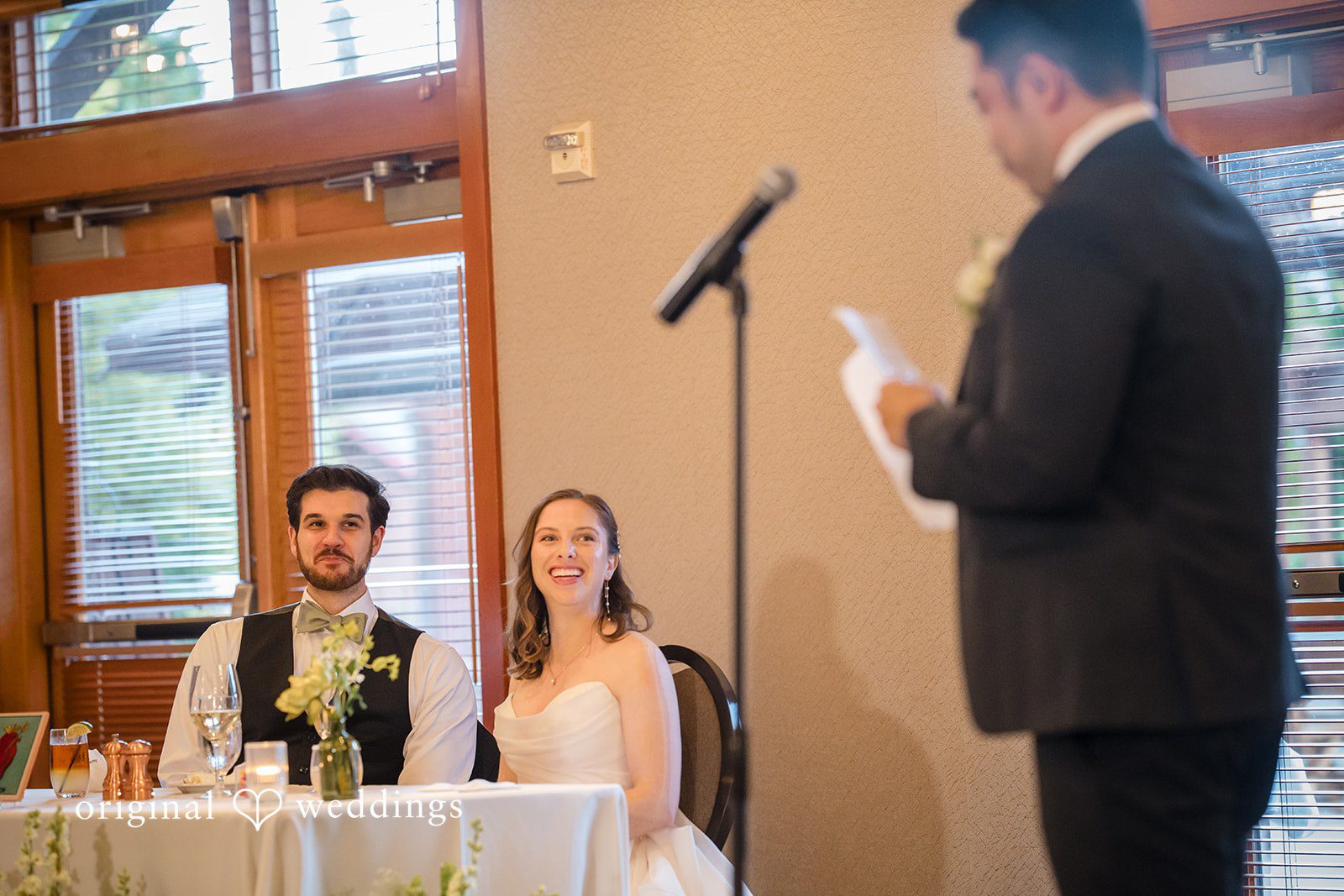 Couple listening to the speech off guest at reception
