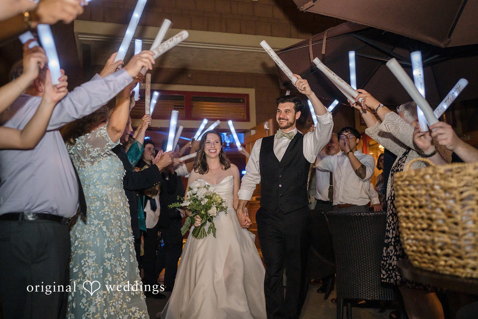 Couple walking through the guests, all cheering up.