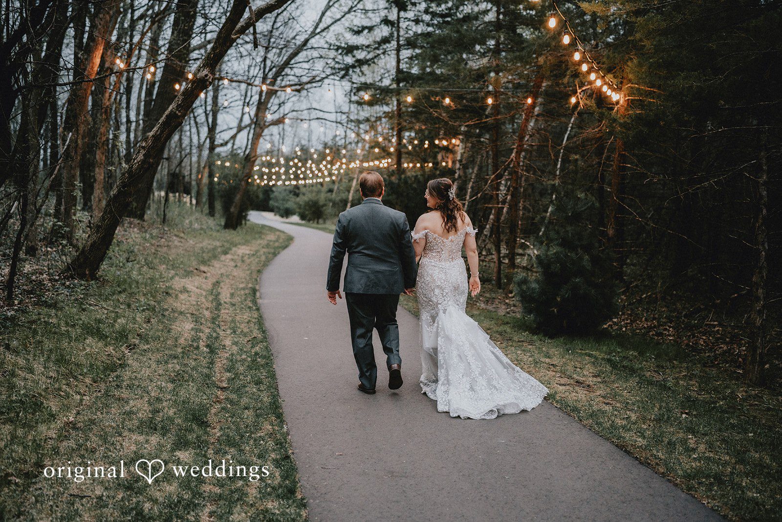 Ashlee + Colby Bride and groom walking through the forest together after the ceremony
