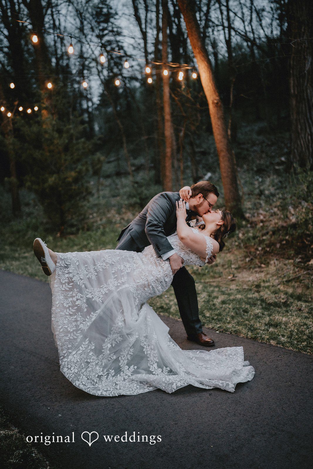 Ashlee + Colby Bride and groom sharing a romantic portrait in the forest outside the venue