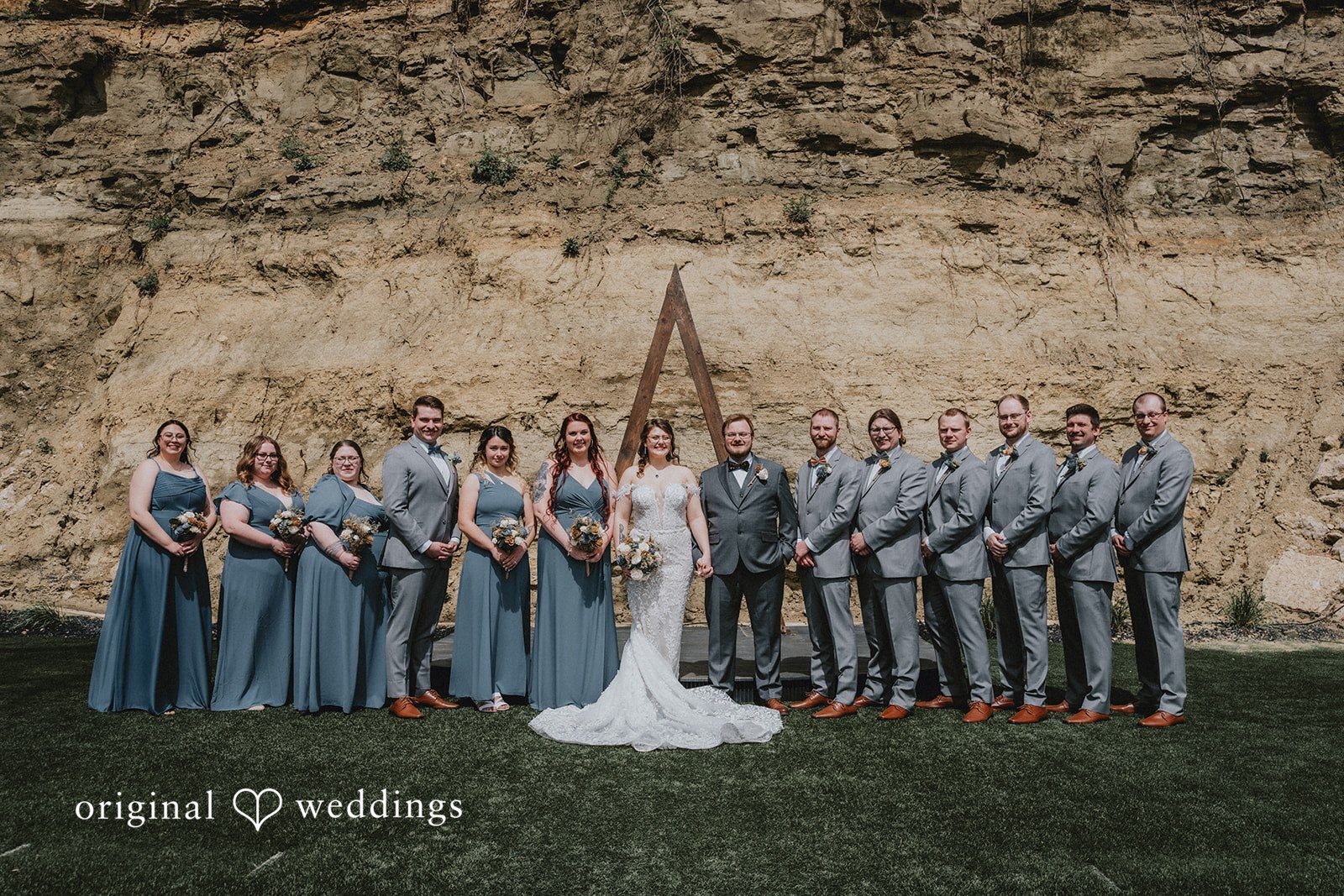 Ashlee + Colby Bride and groom posing with bridesmaids and groomsmen before the ceremony