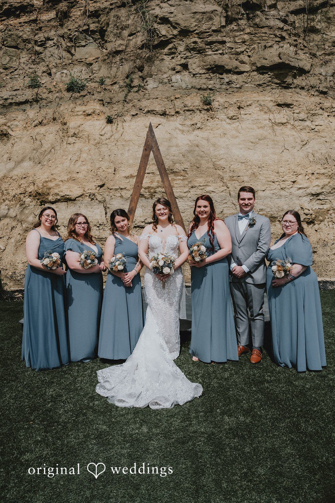 Ashlee + Colby Bride posing with her bridesmaids in a full-length wedding portrait