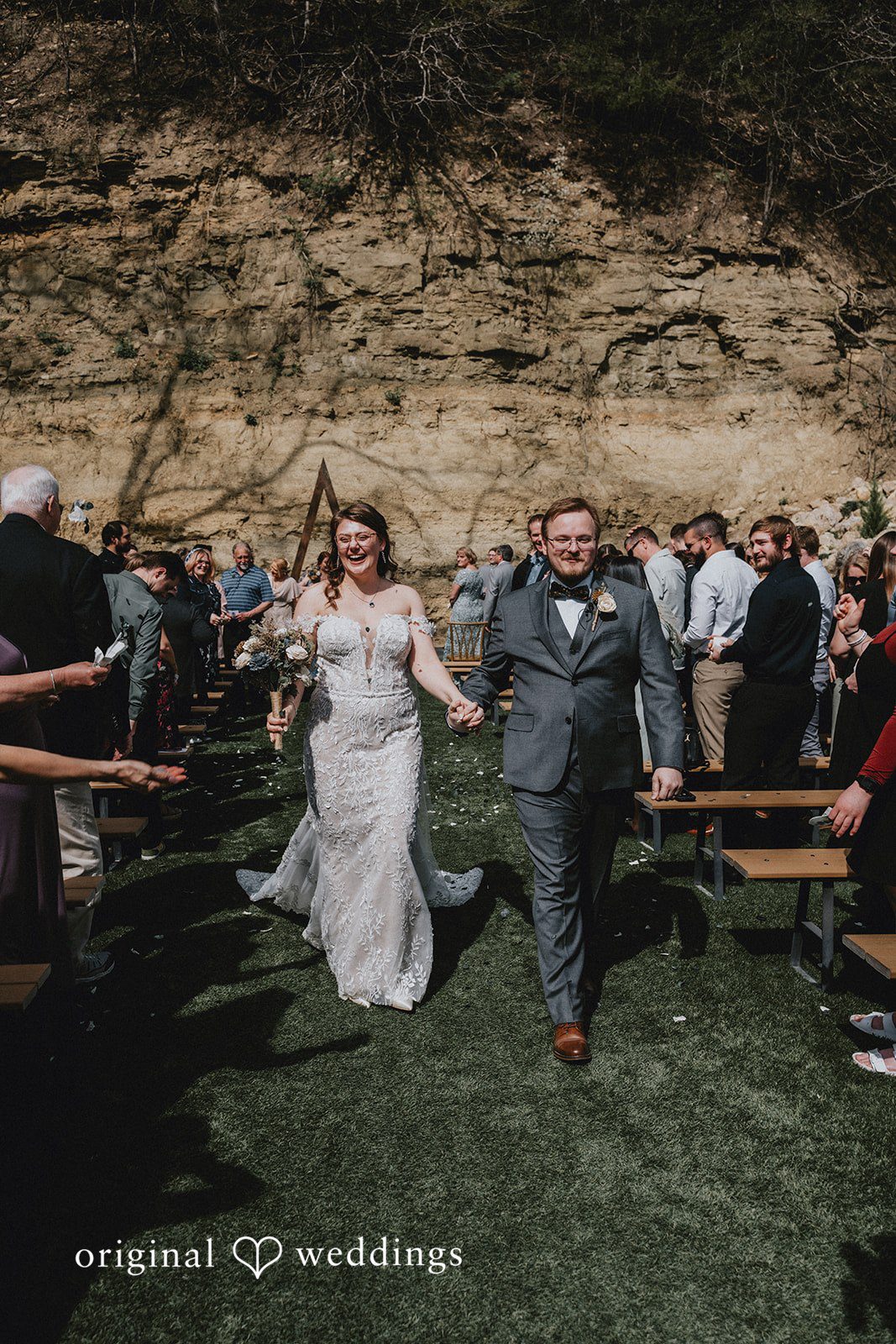 Ashlee + Colby Bride and groom walking hand in hand down the aisle after the ceremony