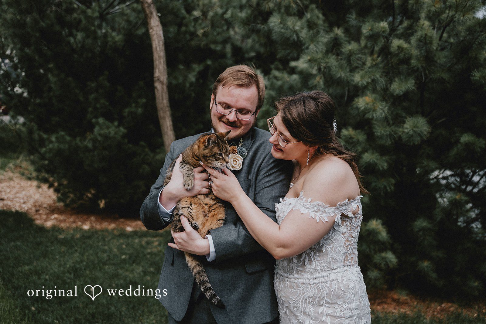 Ashlee + Colby Bride and groom cuddling their cat during a heartfelt wedding portrait