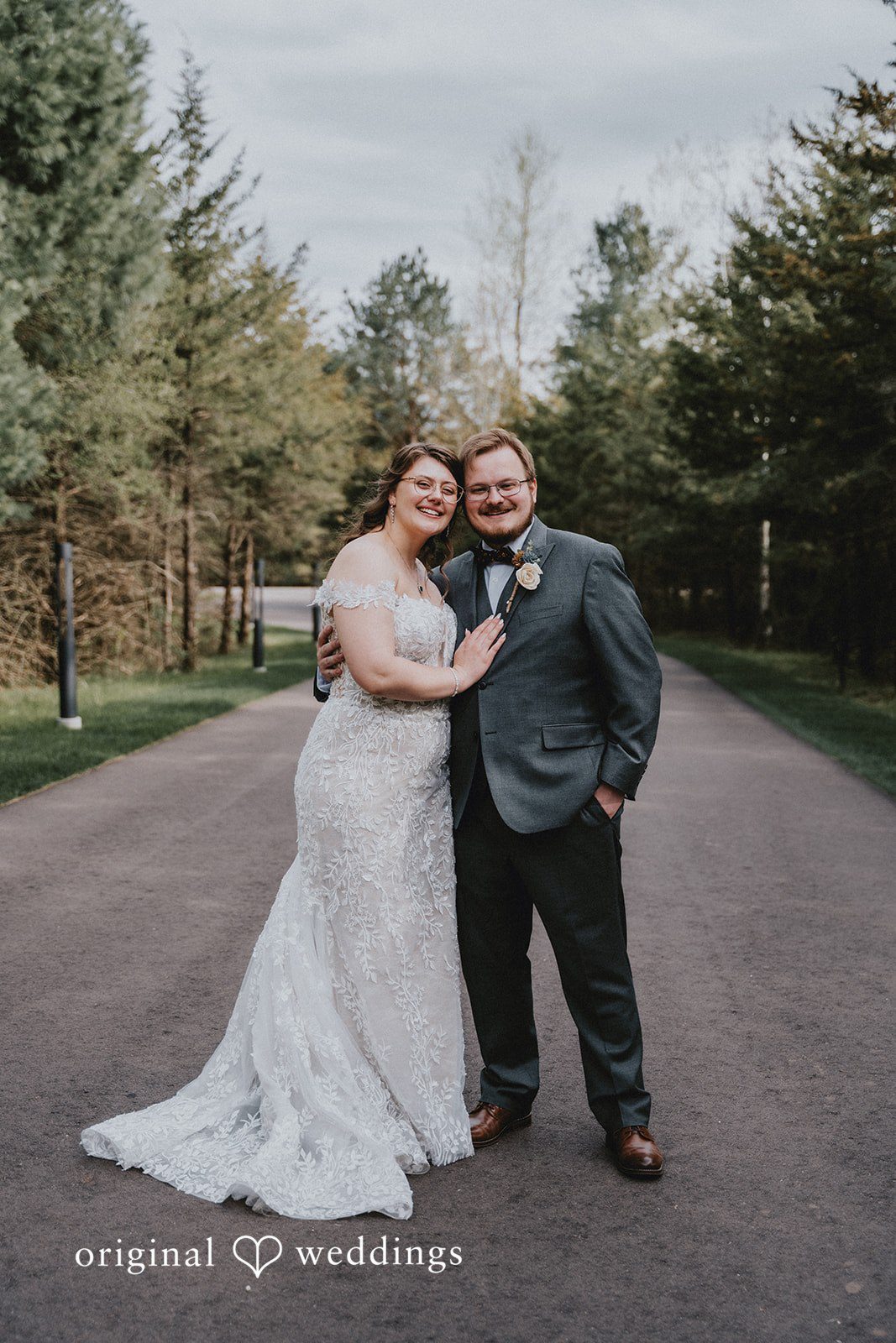 Ashlee + Colby Bride and groom standing together among the trees in a scenic outdoor portrait