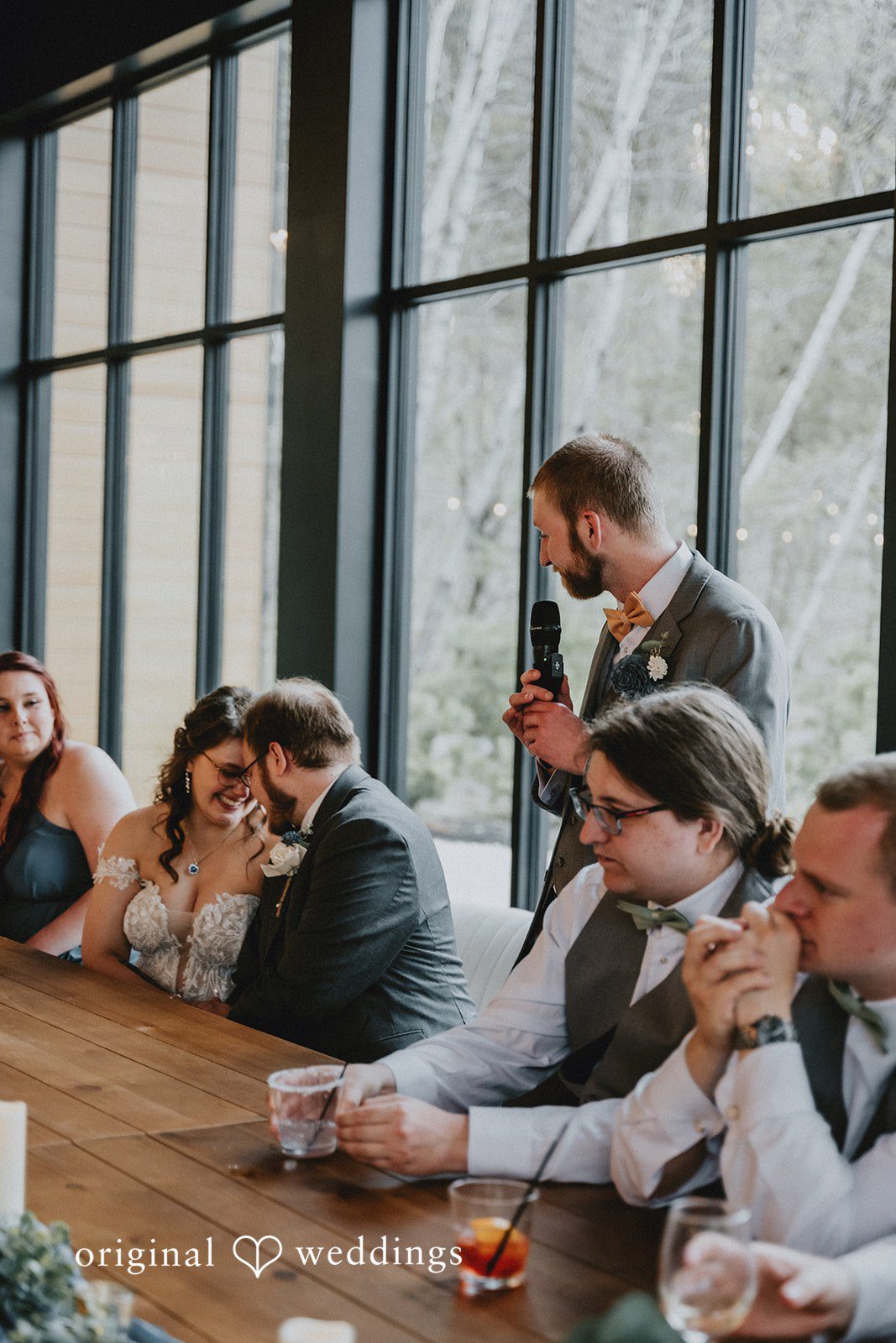 Ashlee + Colby Bride and groom listening to speeches while seated at their reception table