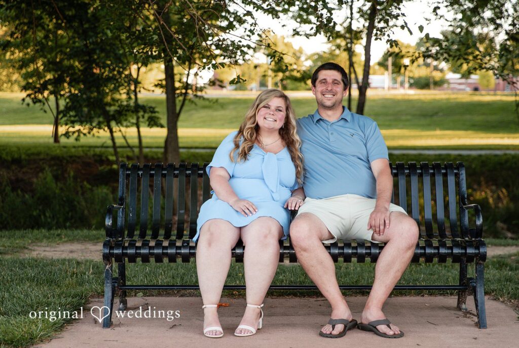 Miranda + Tyler Baltimore Engagement Photographers capturing couple sitting on a bench and smiling at Baker Park by Original Weddings