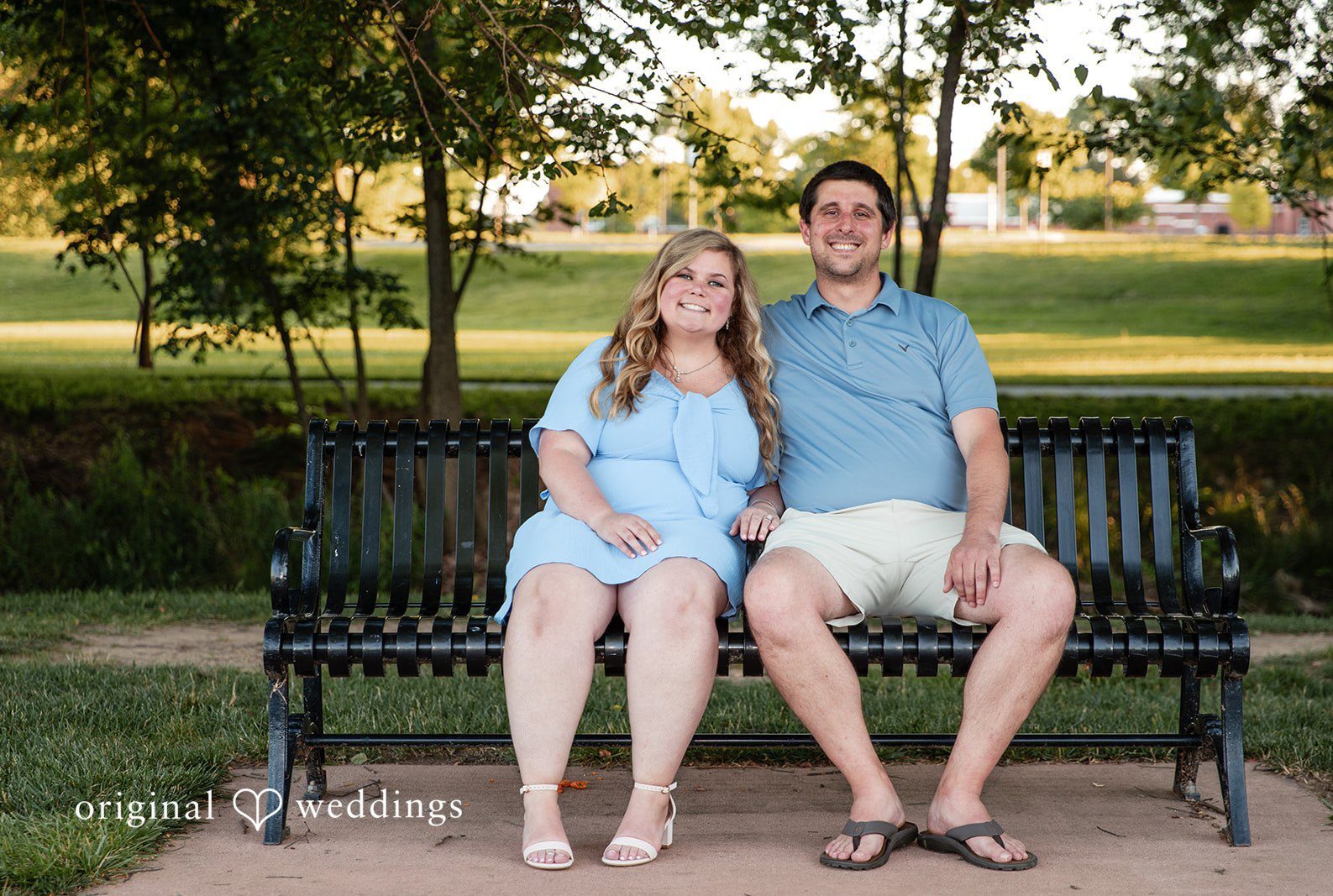 Baltimore Engagement Photographers capturing couple sitting on a bench and smiling at Baker Park by Original Weddings