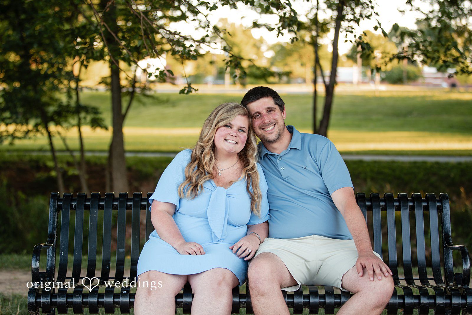 Miranda + Tyler Couple sitting together and smiling during their engagement session at Baker Park