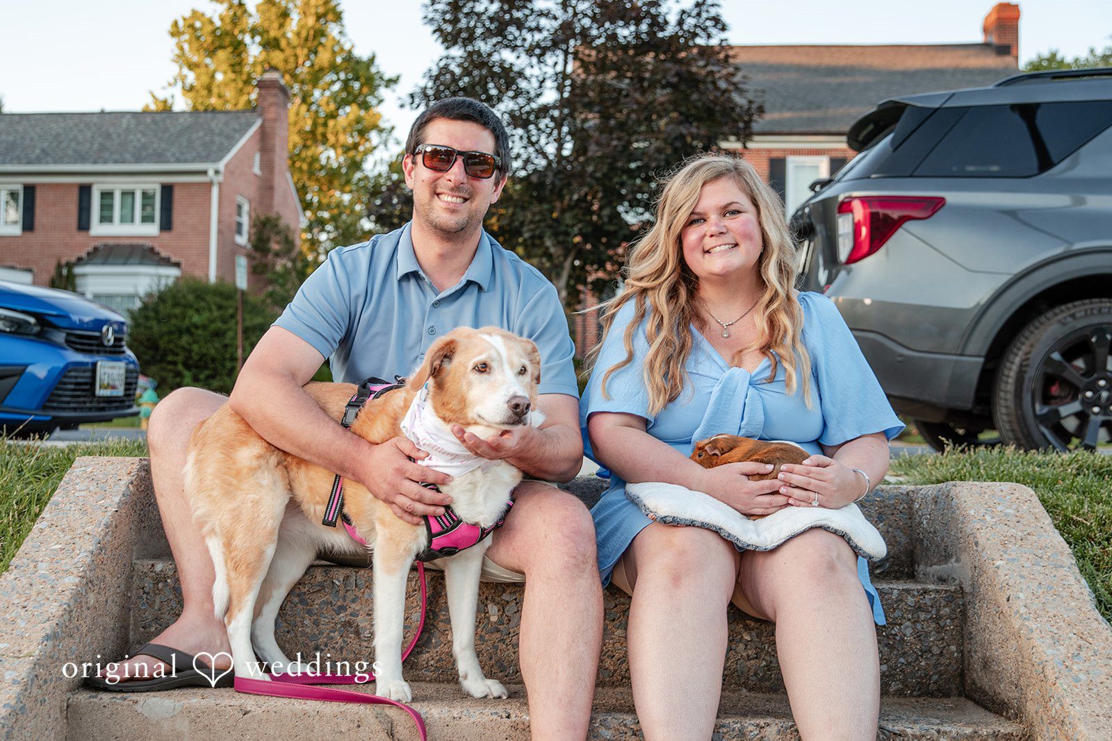 Miranda + Tyler Couple sitting with their dog while smiling at Baker Park