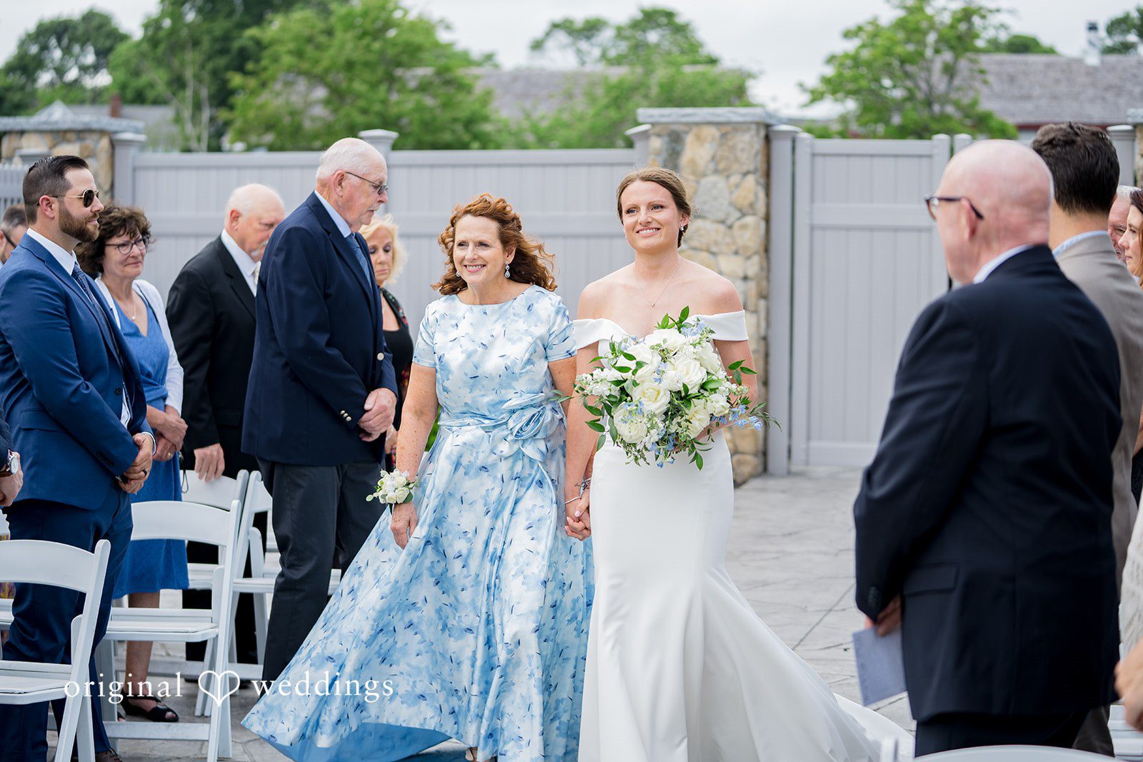 Molly + Joe Bride and woman in a blue patterned dress walks down the aisle.