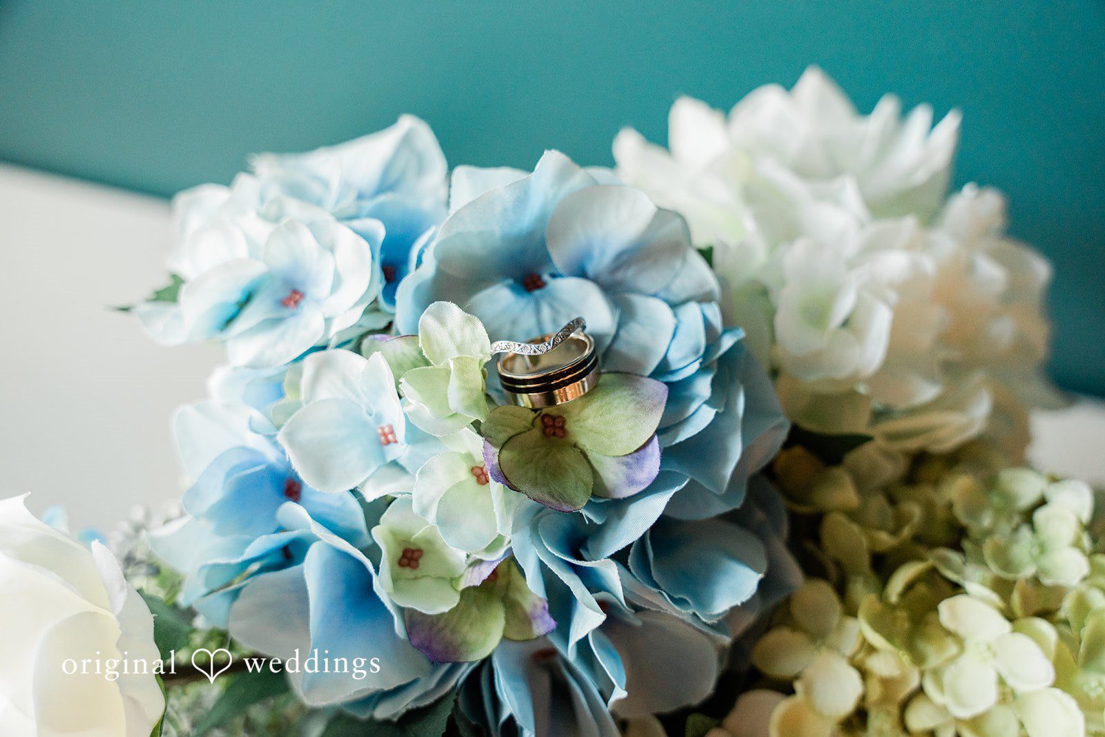 Rachel + Nick Close-up of wedding rings among the flowers at Batch No. 154