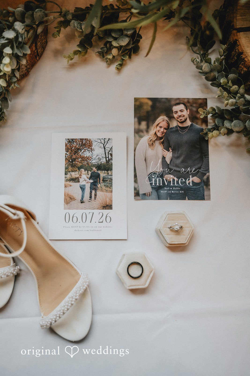 Neil + Hallie A flat lay arrangement of bridal accessories, a photo, and a guest book.