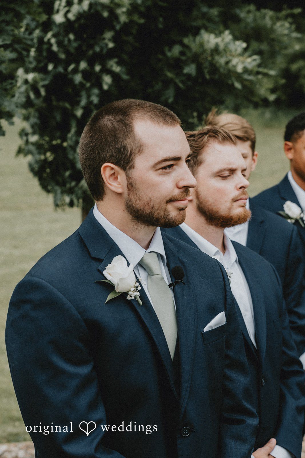 Neil + Hallie Profile shot of a groom looking forward alongside his groomsmen.