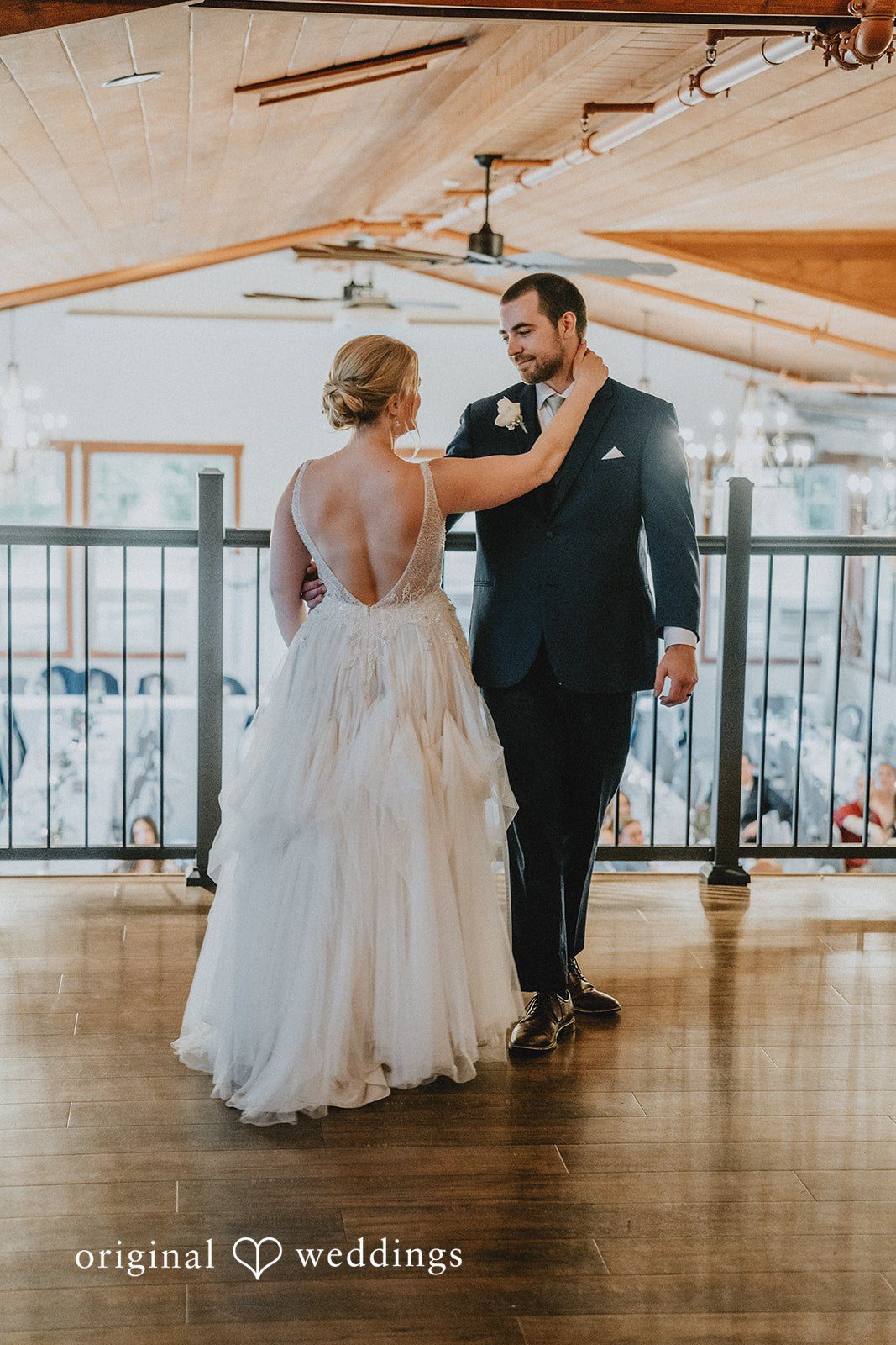 Neil + Hallie A bride and groom sharing a dance on a wooden dance floor.