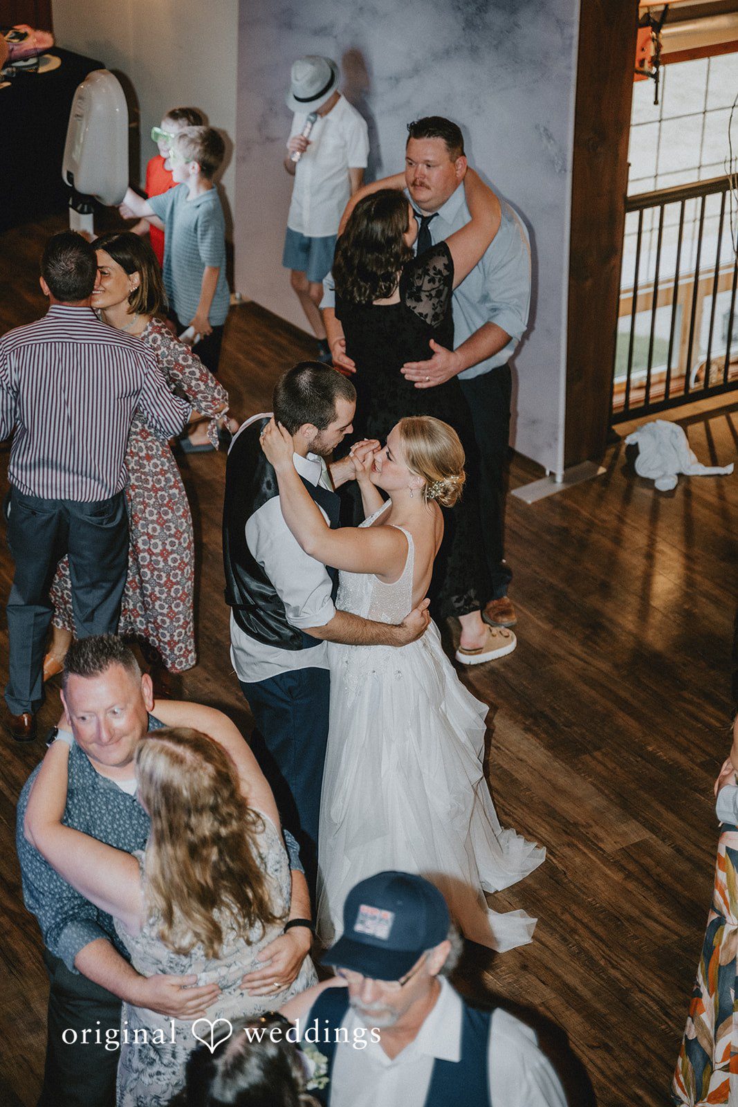 Neil + Hallie Wedding guests dancing and celebrating together at a reception party.