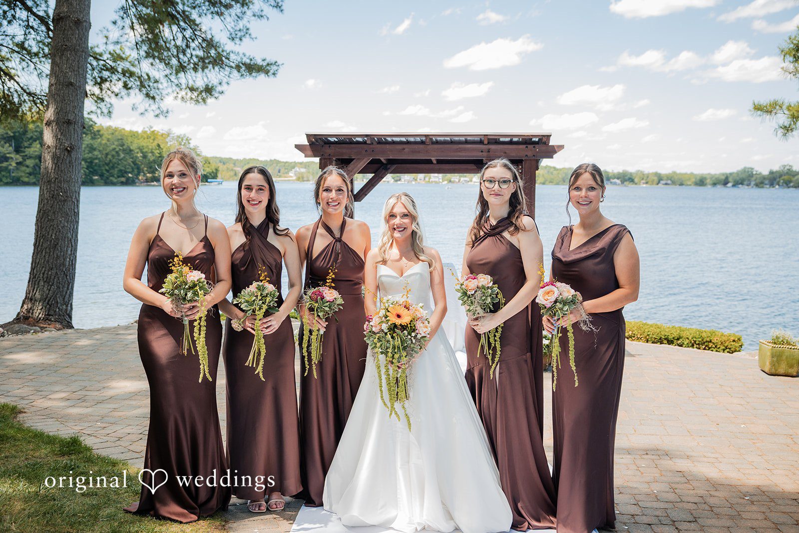 Trey + Bailey Bride with bridesmaids beside the lake at Blake's Backyard