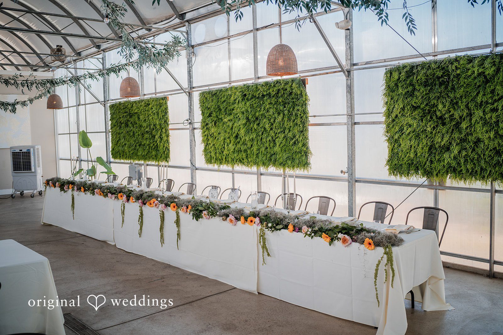 Trey + Bailey Elegant floral head table with greenery at Blake's Backyard.
