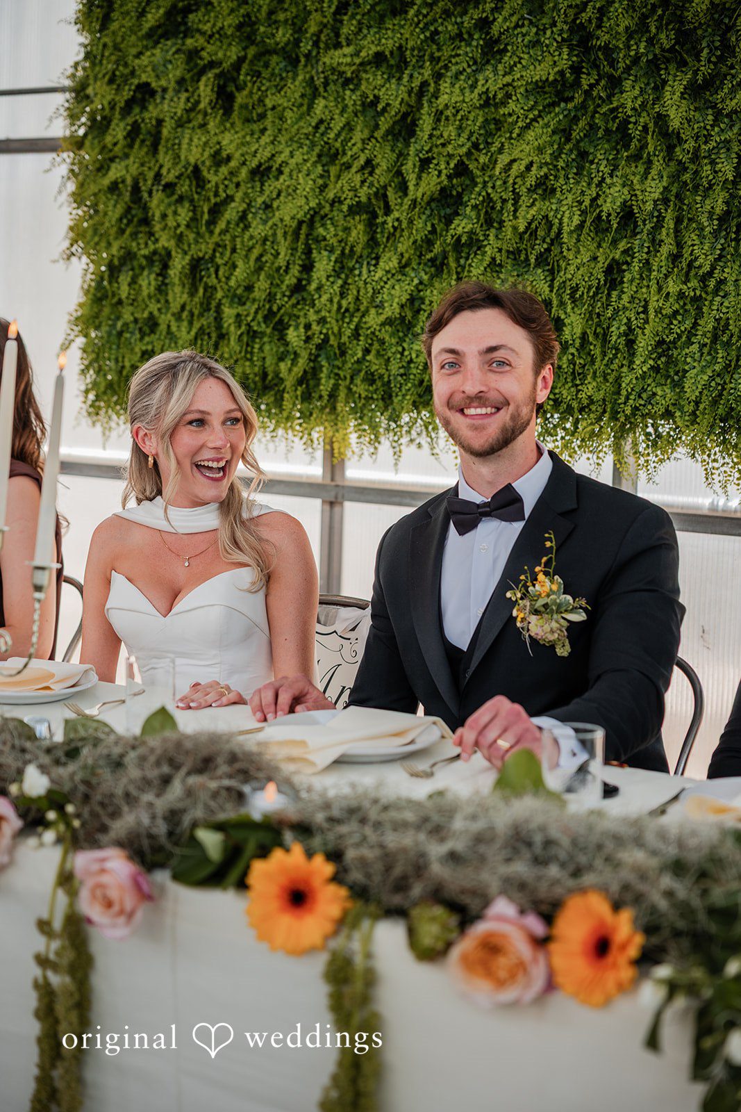 Trey + Bailey Newlyweds smiling together during their wedding reception at Blake’s Backyard.