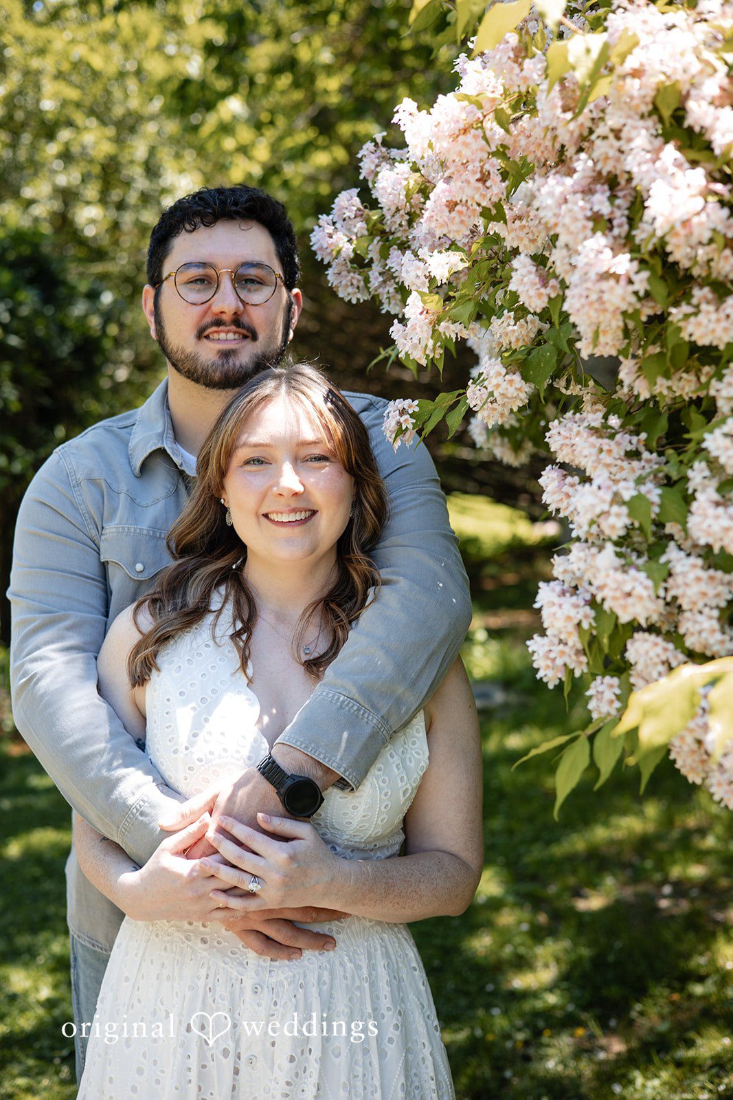 Groom embracing the bride from behind during their engagement session at Borderland State Park