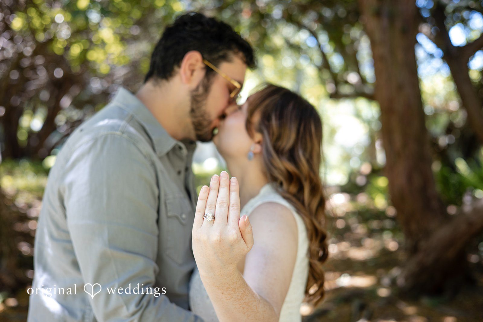 Bride displaying her engagement ring during a kiss at Borderland State Park