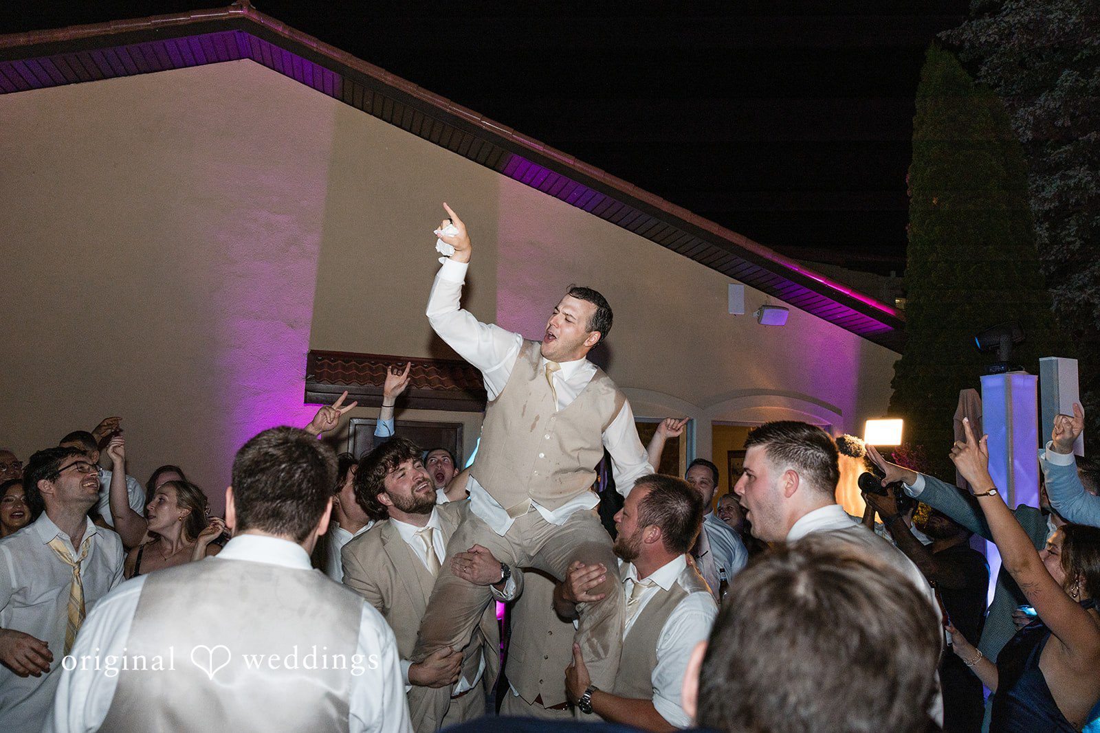 Brett + Ava Groom having a fun time with his family and friends at Breaux Vineyards