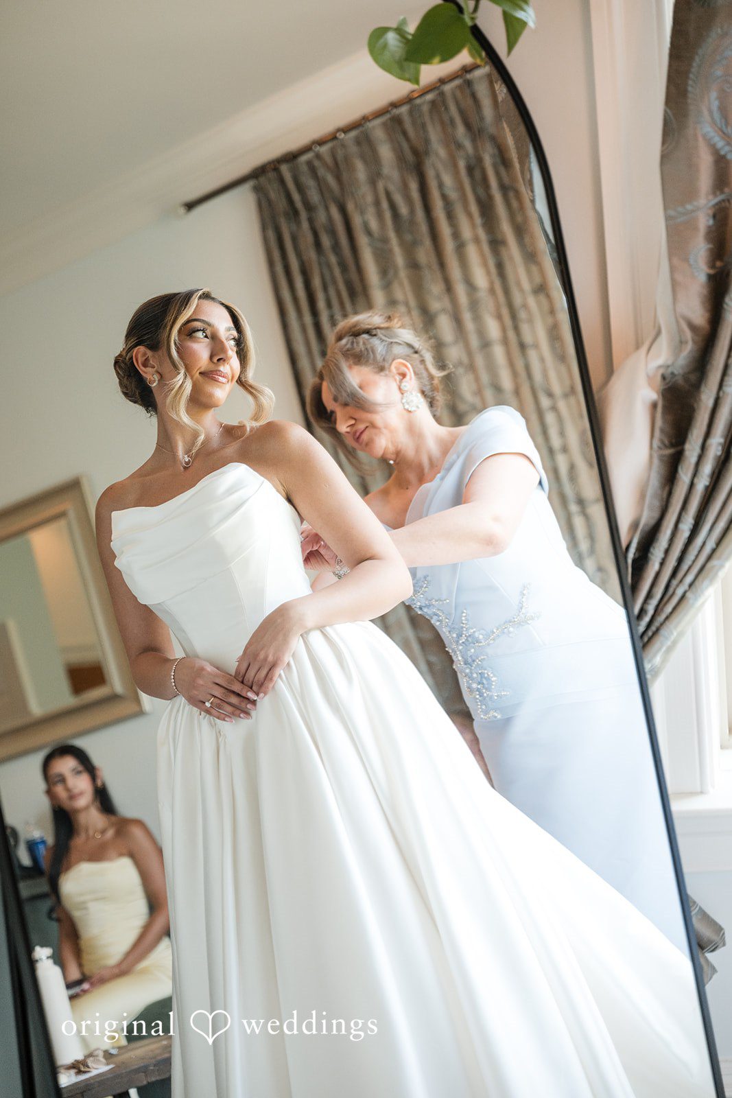 Brett + Ava Lovely bride getting ready with help of someone at Breaux Vineyards
