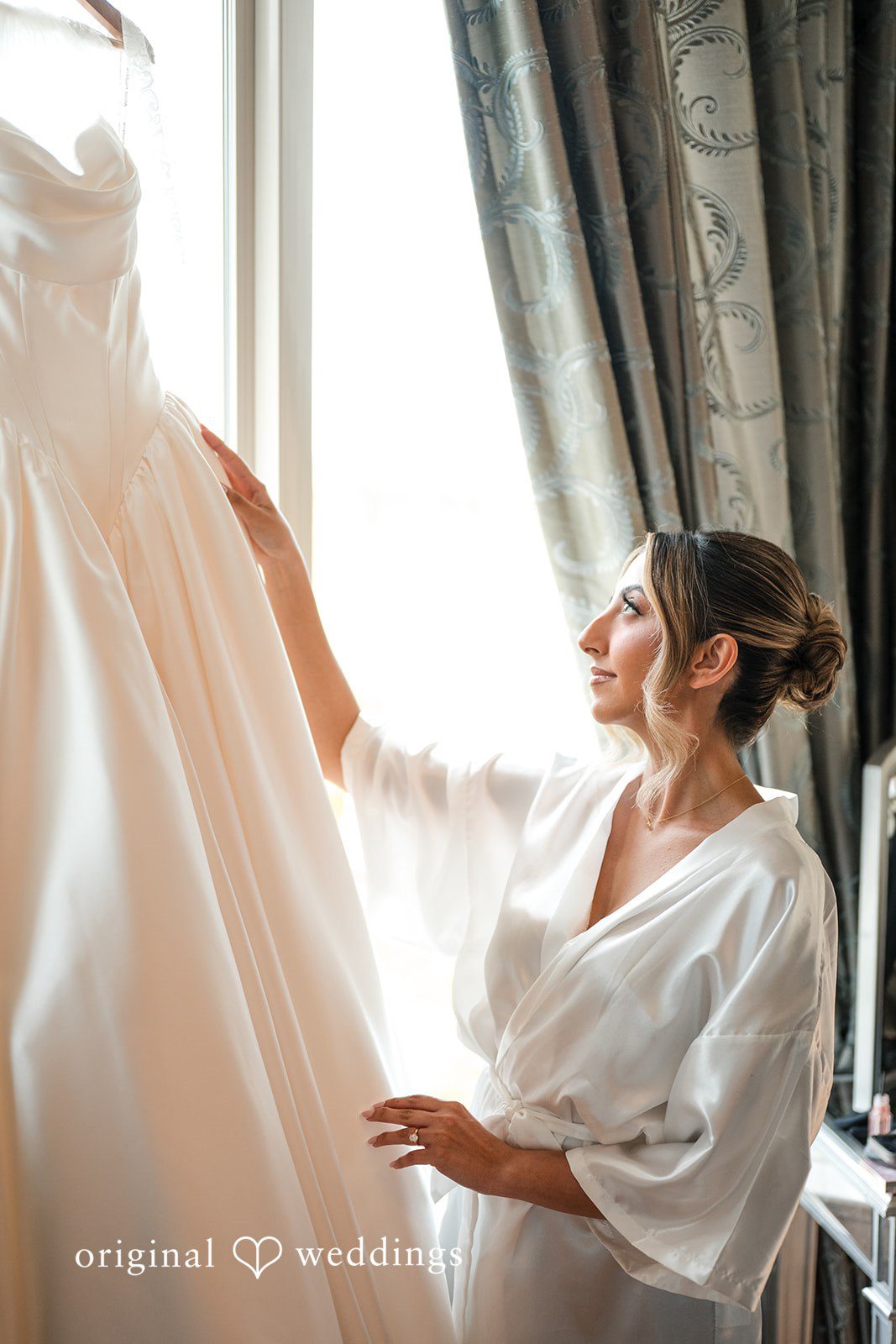 Brett + Ava Lovely bride admiring her wedding dress at Breaux Vineyards