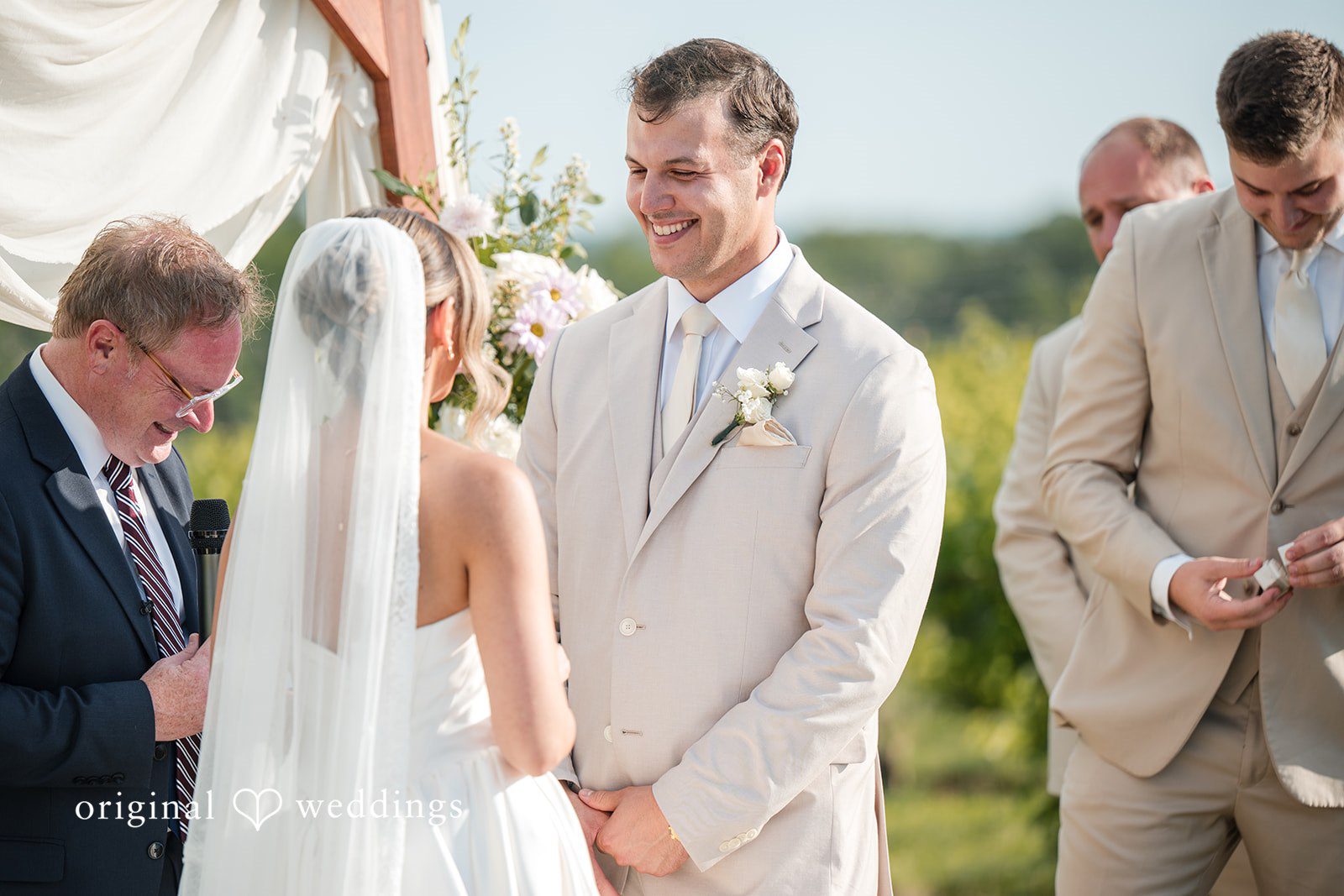 Brett + Ava Bride and groom exchanging vows during wedding ceremony at Breaux Vineyards