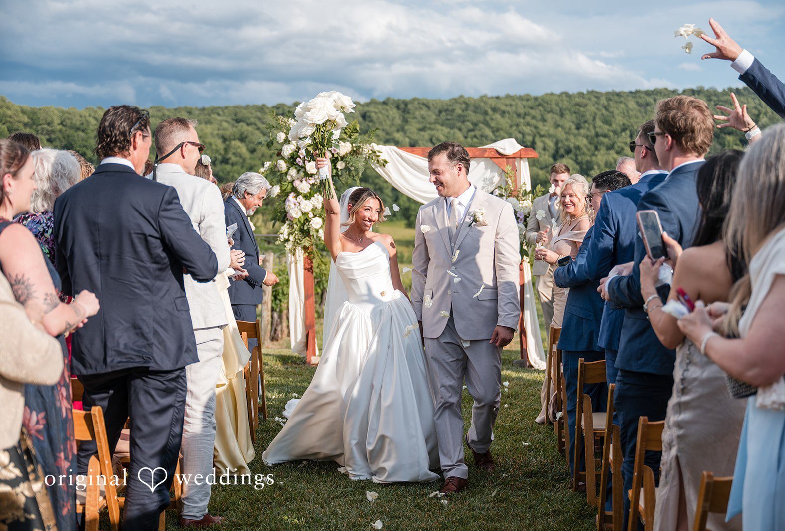 Bride and groom leaving the altar with happiness at Breaux Vineyards captured by DC wedding photographers from Original Weddings