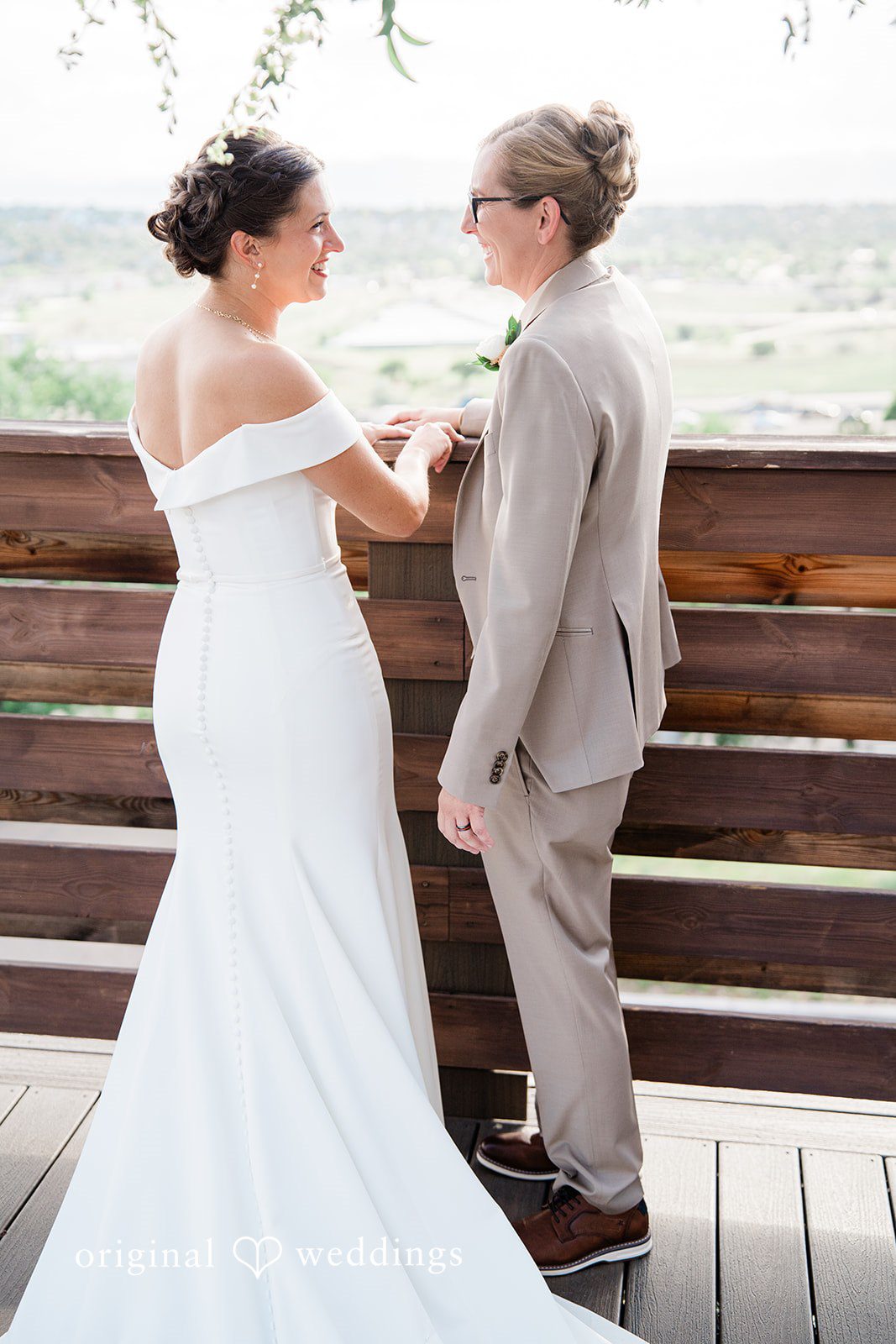 Rachel & Krystal A wedding couple standing side-by-side facing away from the camera.
