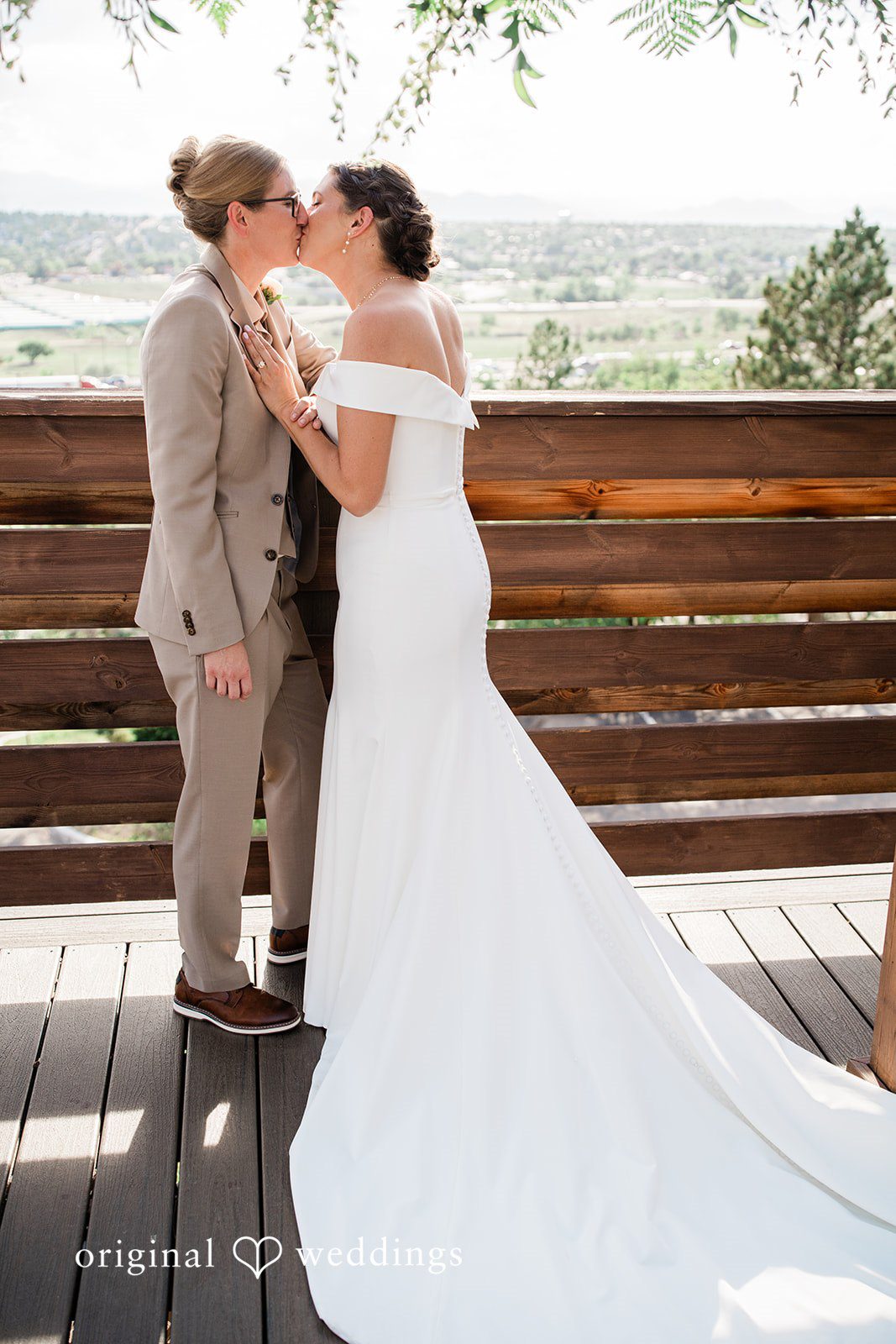 Rachel & Krystal A wedding couple embracing while overlooking a scenic view.