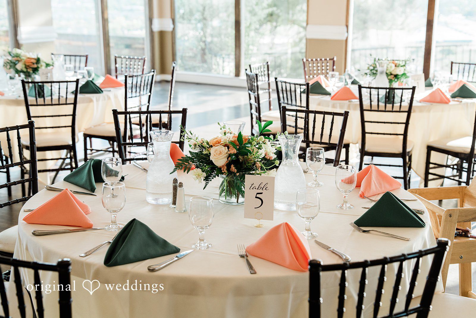 Rachel & Krystal Multiple reception tables set up with round tablecloths and folding chairs.