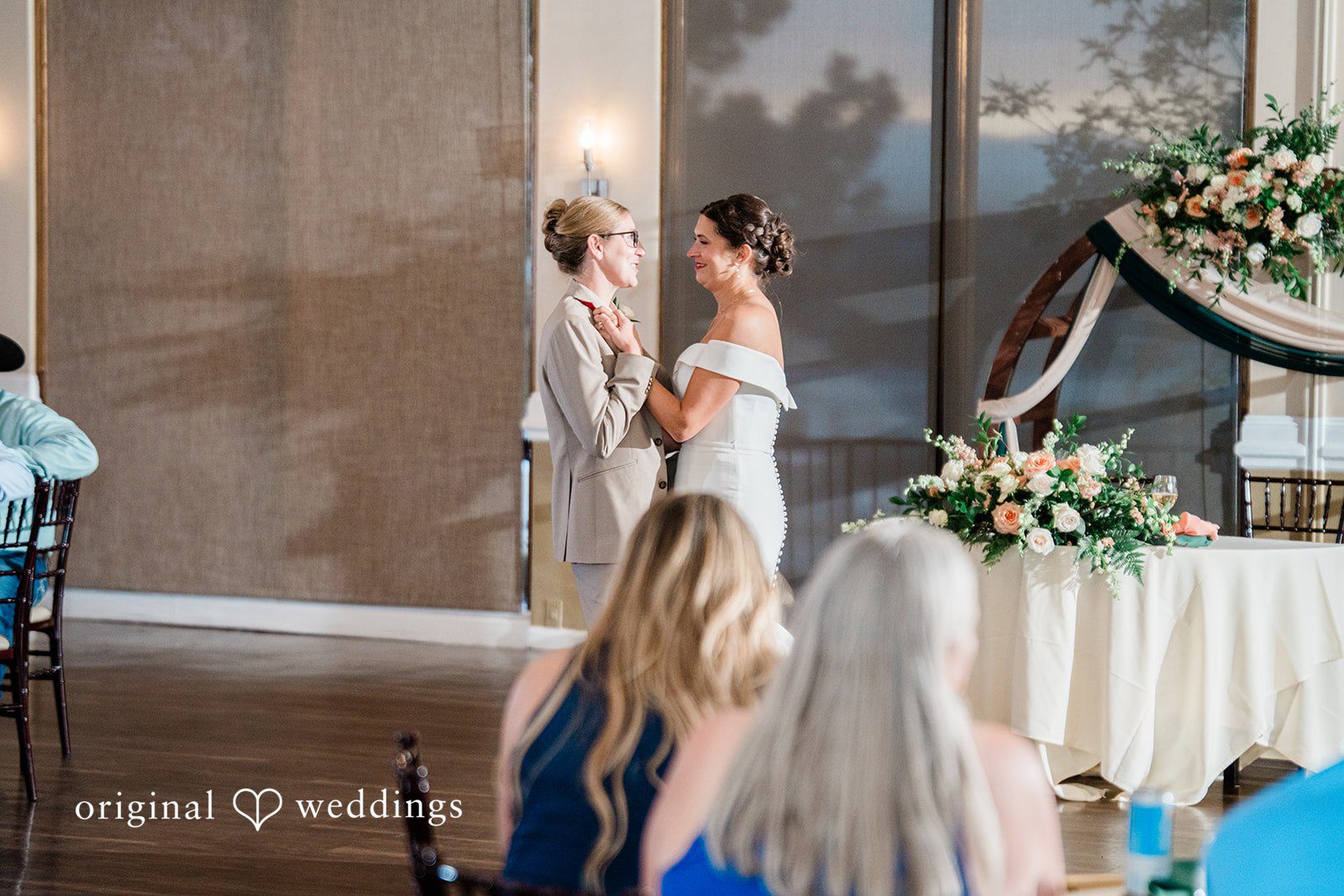 Rachel & Krystal Couple dancing together in the center of a reception room.