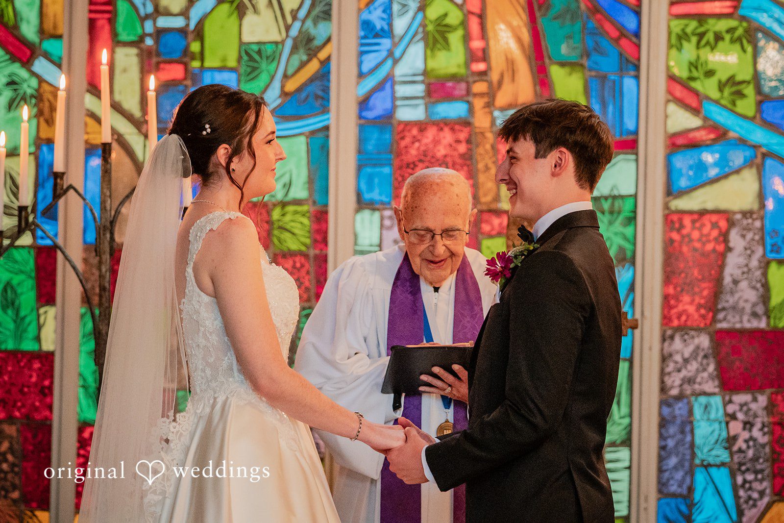Jacob + Jadee Bride and groom holding hands during the ceremony at Callaway Gardens Ida Memorial Chapel captured by Atlanta Wedding Photographers from Original Weddings