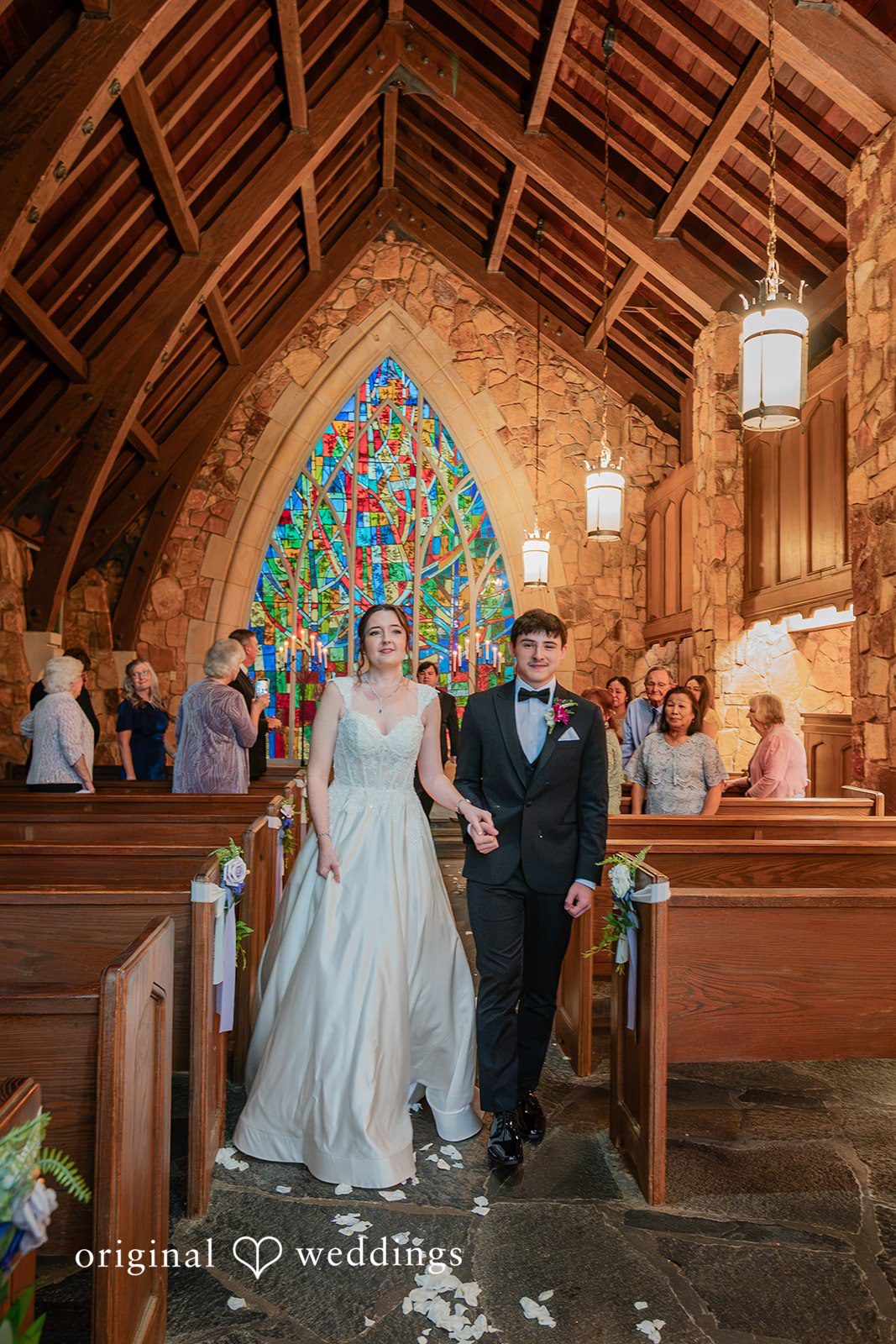 Jacob + Jadee Happy newlyweds walking hand in hand down the chapel aisle at Callaway Gardens Ida Memorial Chapel