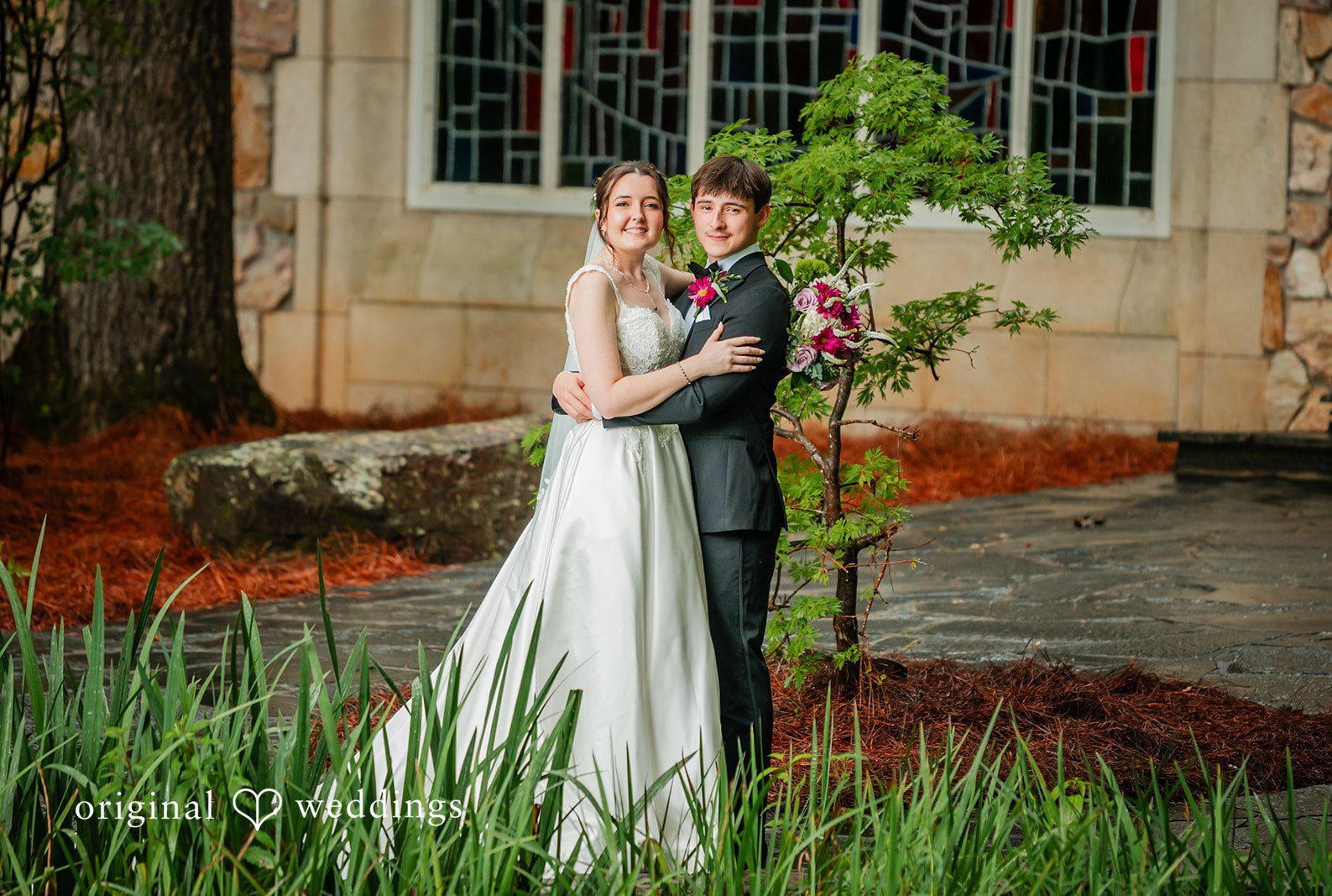 Bride and groom embracing outside Callaway Gardens Ida Memorial Chapel captured by Atlanta Wedding Photographers from Original Weddings.