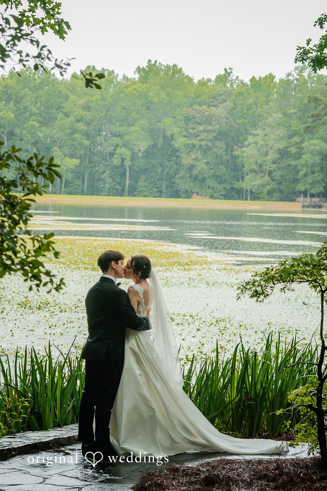 Jacob + Jadee Wedding kiss overlooking the peaceful lake at Callaway Gardens Ida Memorial Chapel.
