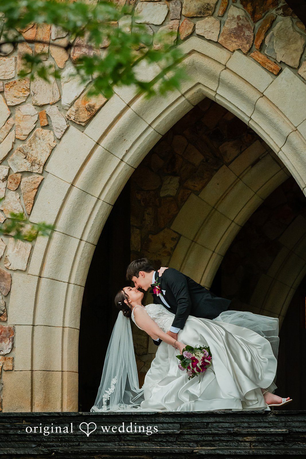 Jacob + Jadee Bride and groom sharing a dip kiss at Callaway Gardens Ida Memorial Chapel captured by Atlanta Wedding Photographers from Original Weddings.