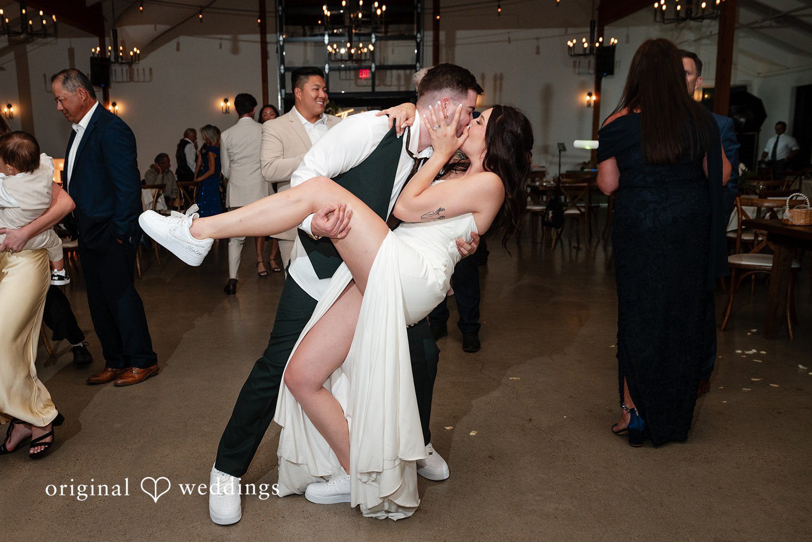 Noah + Jade A groom playfully dipping and lifting his bride on the dance floor during the reception.