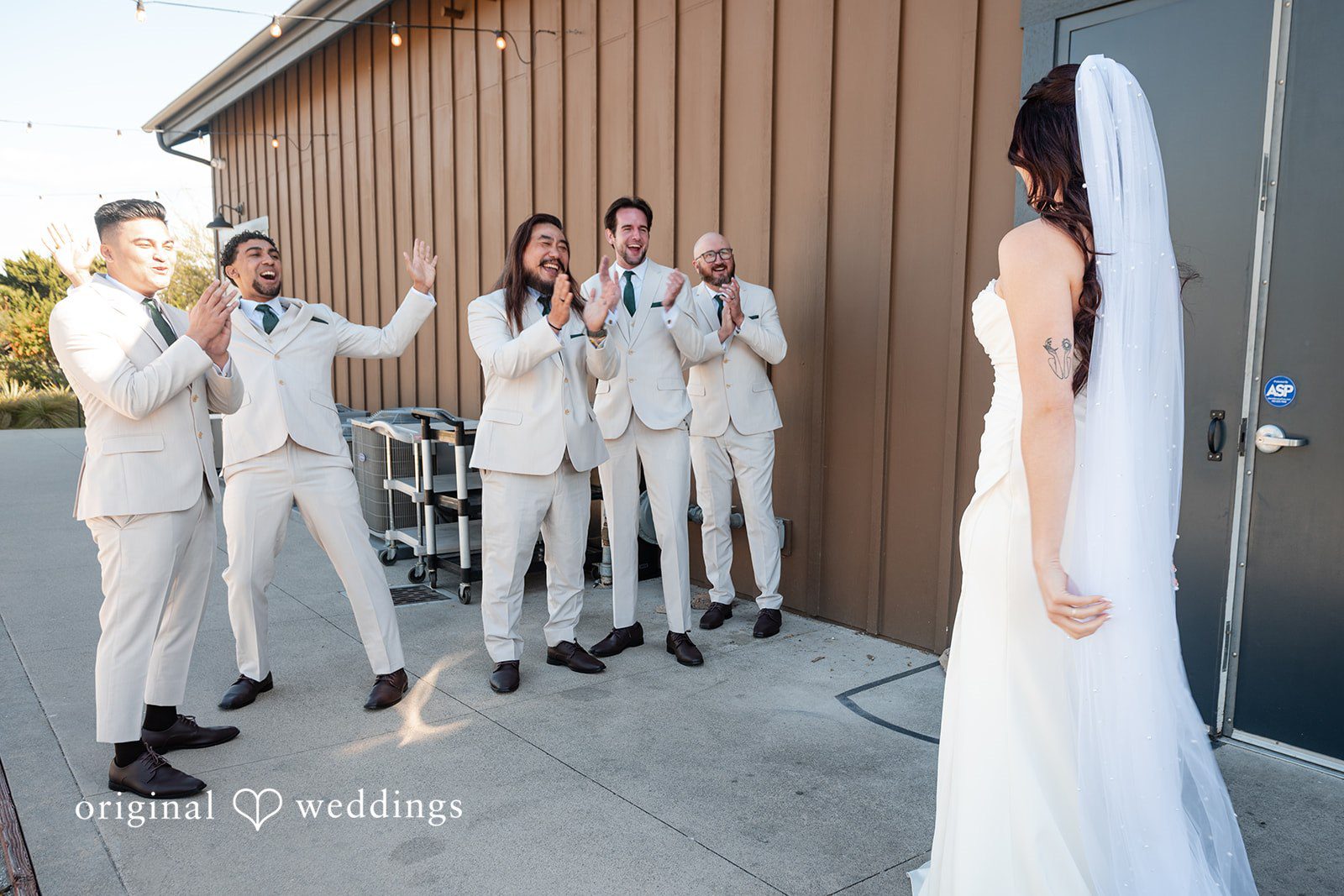 Noah + Jade Five groomsmen reacting with surprise and excitement as they turn around to look at the bride.