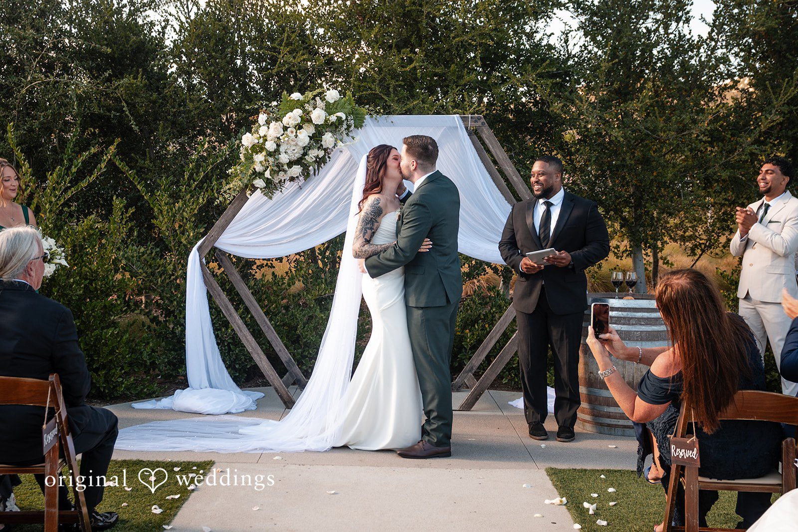 Noah + Jade A bride and groom share a first kiss at Canopy Grove.