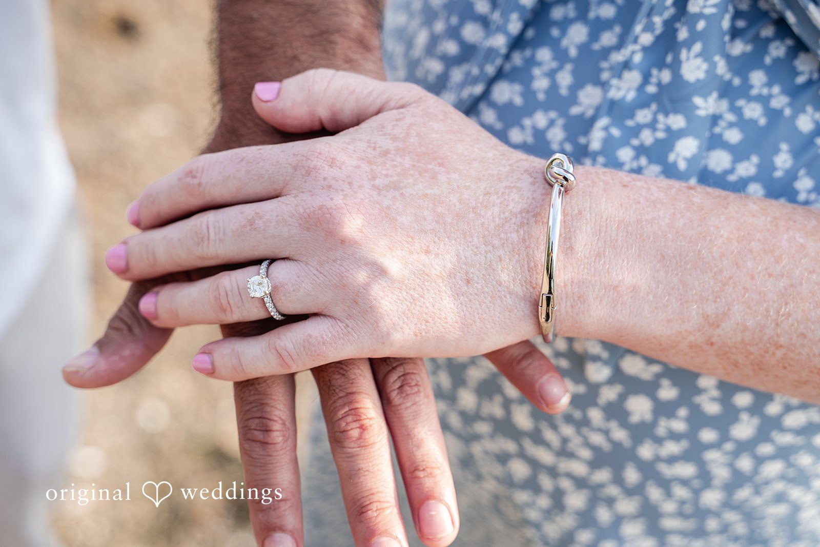 Kelly + Geoffrey Close-up of a hand showing an engagement ring at Castle Island.