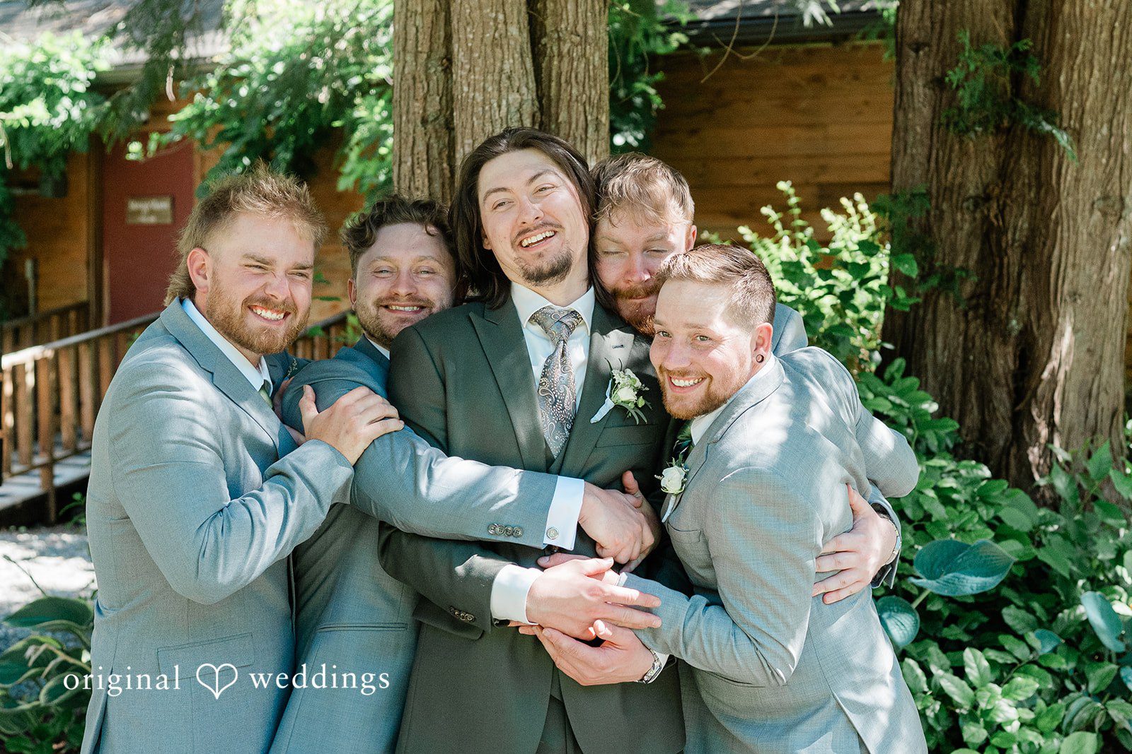 Jennifer + Steven Groom smiling with the groomsmen before the ceremony at cedar springs