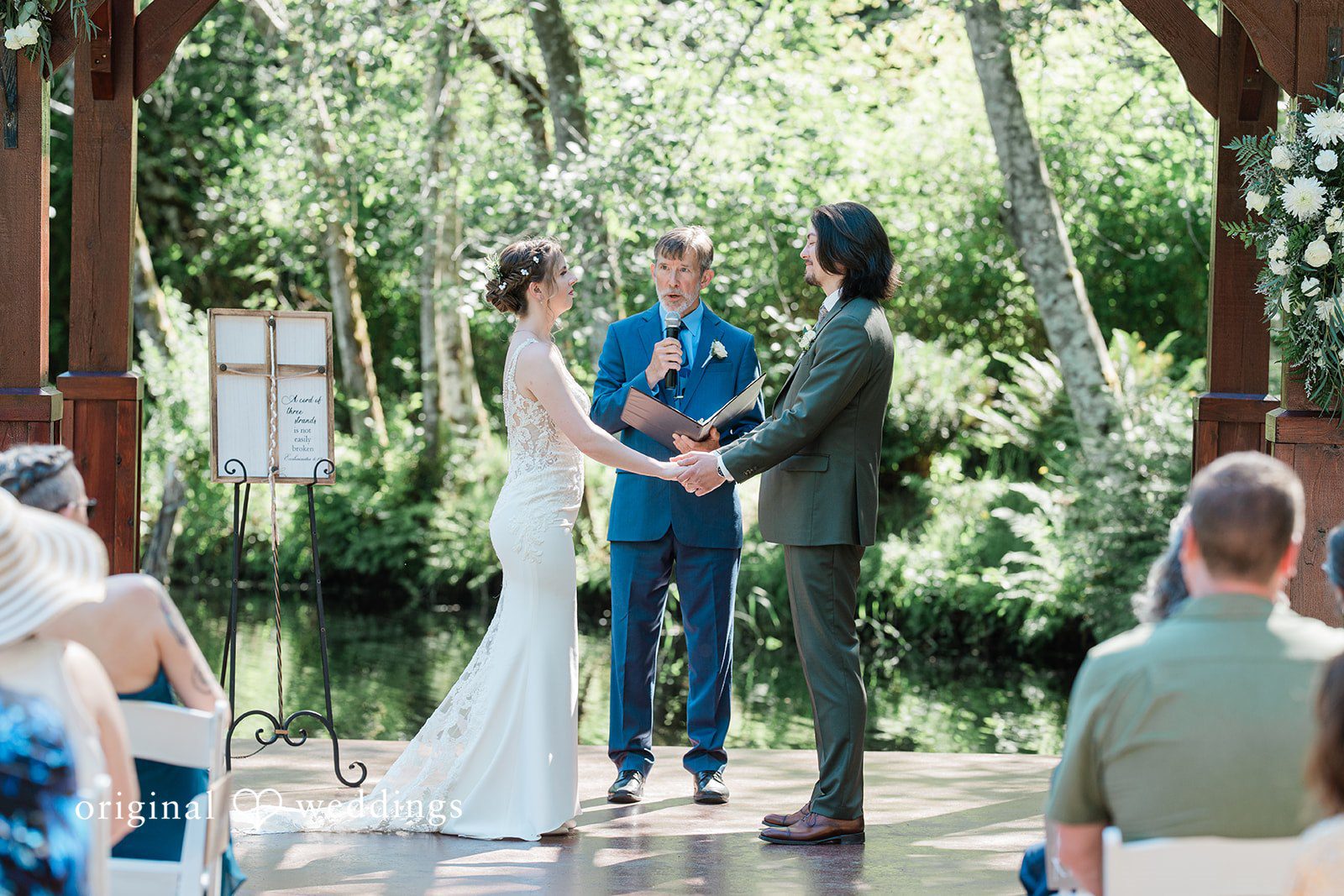 Jennifer + Steven Couple standing before the priest while looking at each other at cedar springs