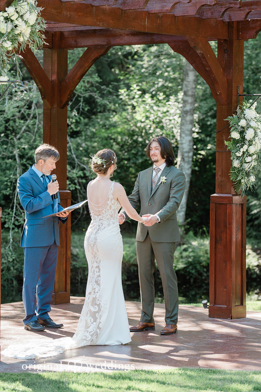 Jennifer + Steven Bride and groom sharing eye contact before the priest at cedar springs