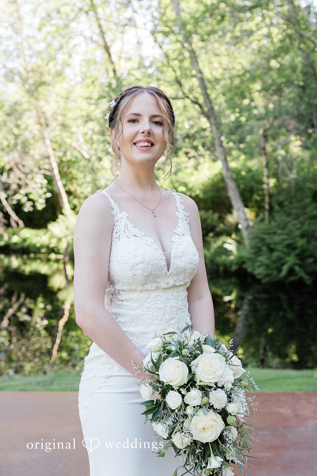 Jennifer + Steven Bride smiling while holding a bouquet at cedar springs