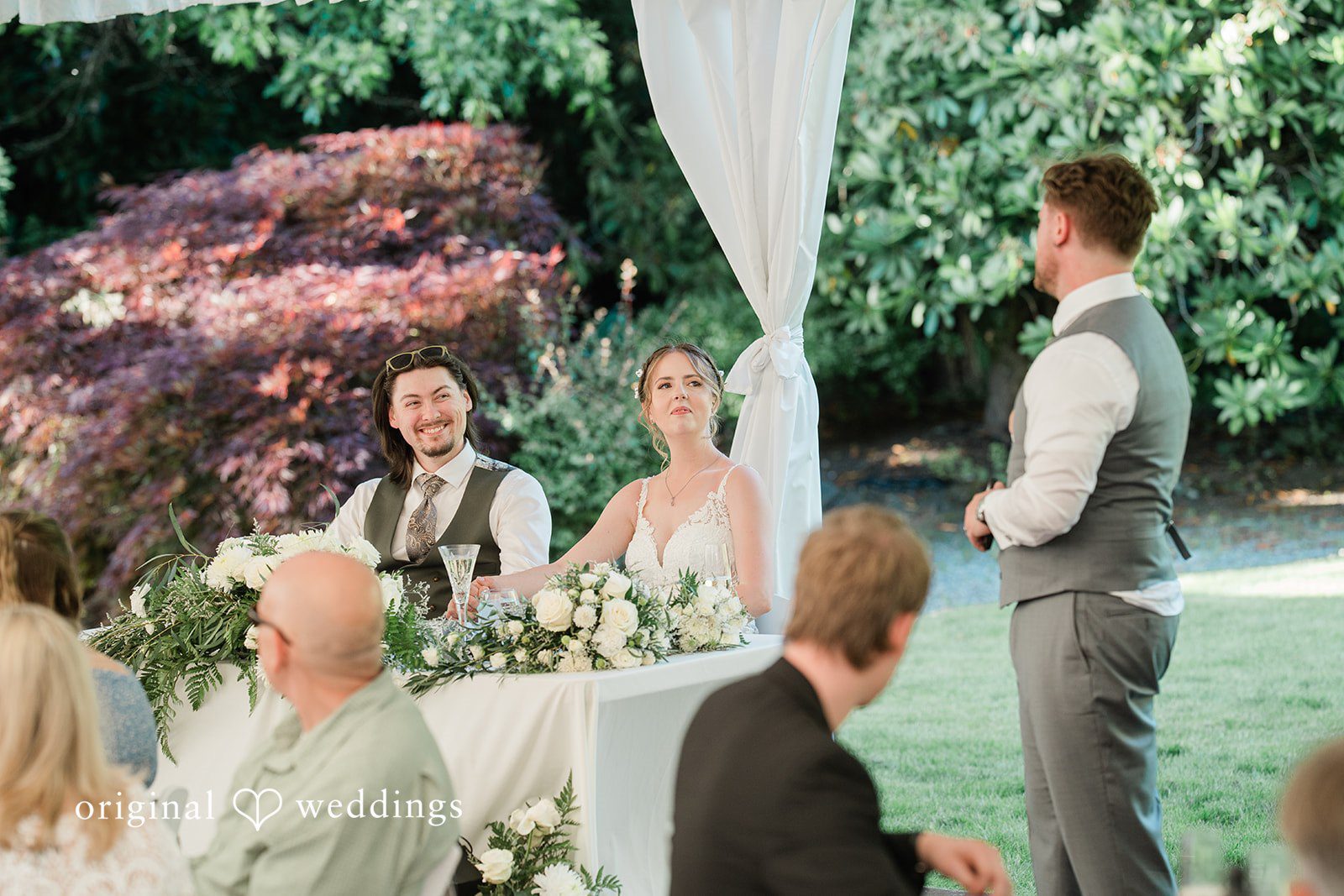 Jennifer + Steven Seattle wedding photographers capturing couple sitting at the reception table at cedar springs by Original Weddings