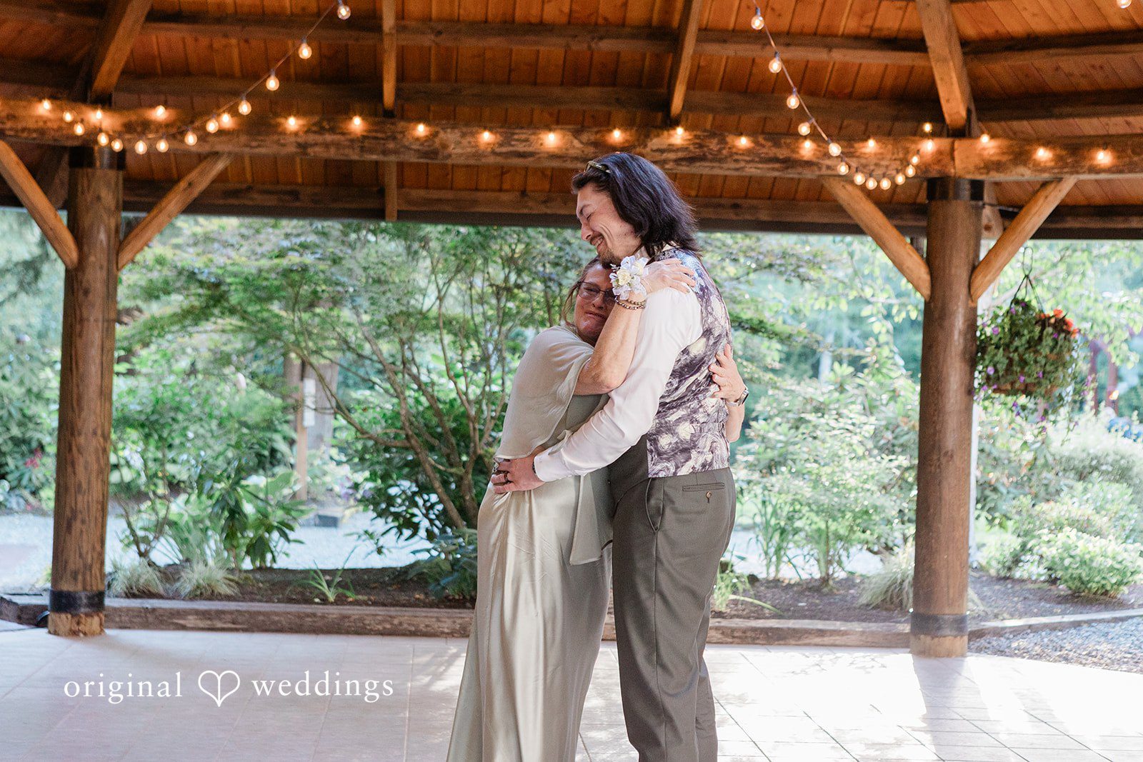 Jennifer + Steven Groom hugging someone during the reception at cedar springs