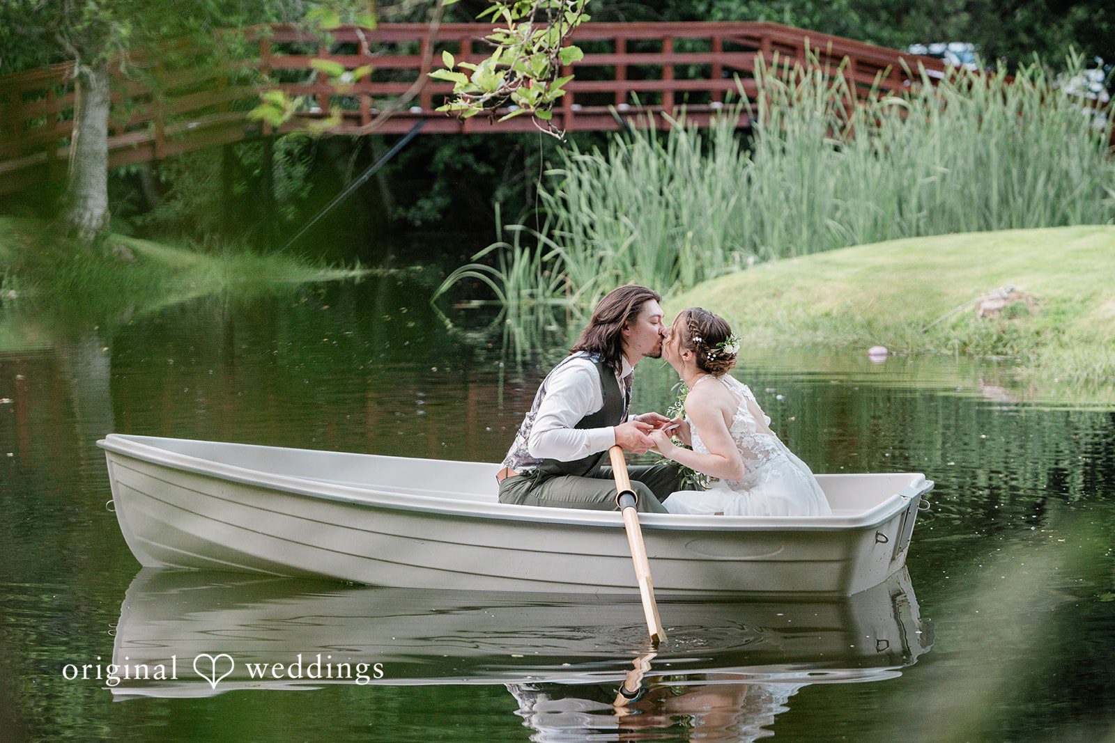 Jennifer + Steven Seattle wedding photographers capturing couple sitting on a boat kissing at cedar springs by Original Weddings